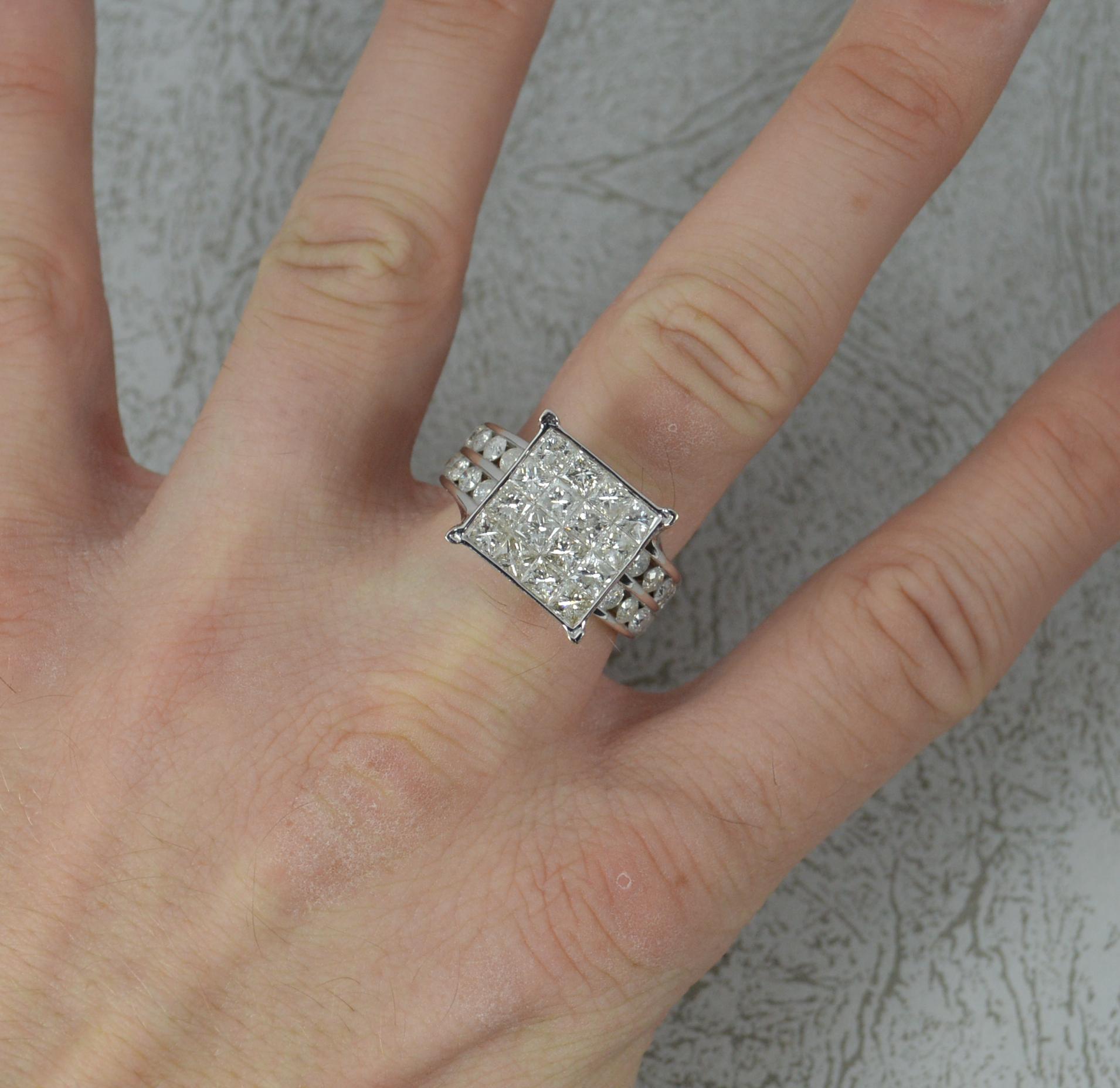 A stunning 4.50 carat diamond and 9ct gold cluster ring.
​Solid 9ct white gold shank and setting.
​Designed with a 4x4 princess cut diamond head to the centre, 12mm x 12mm, all in a tension setting. To each side are a further two rows of four round