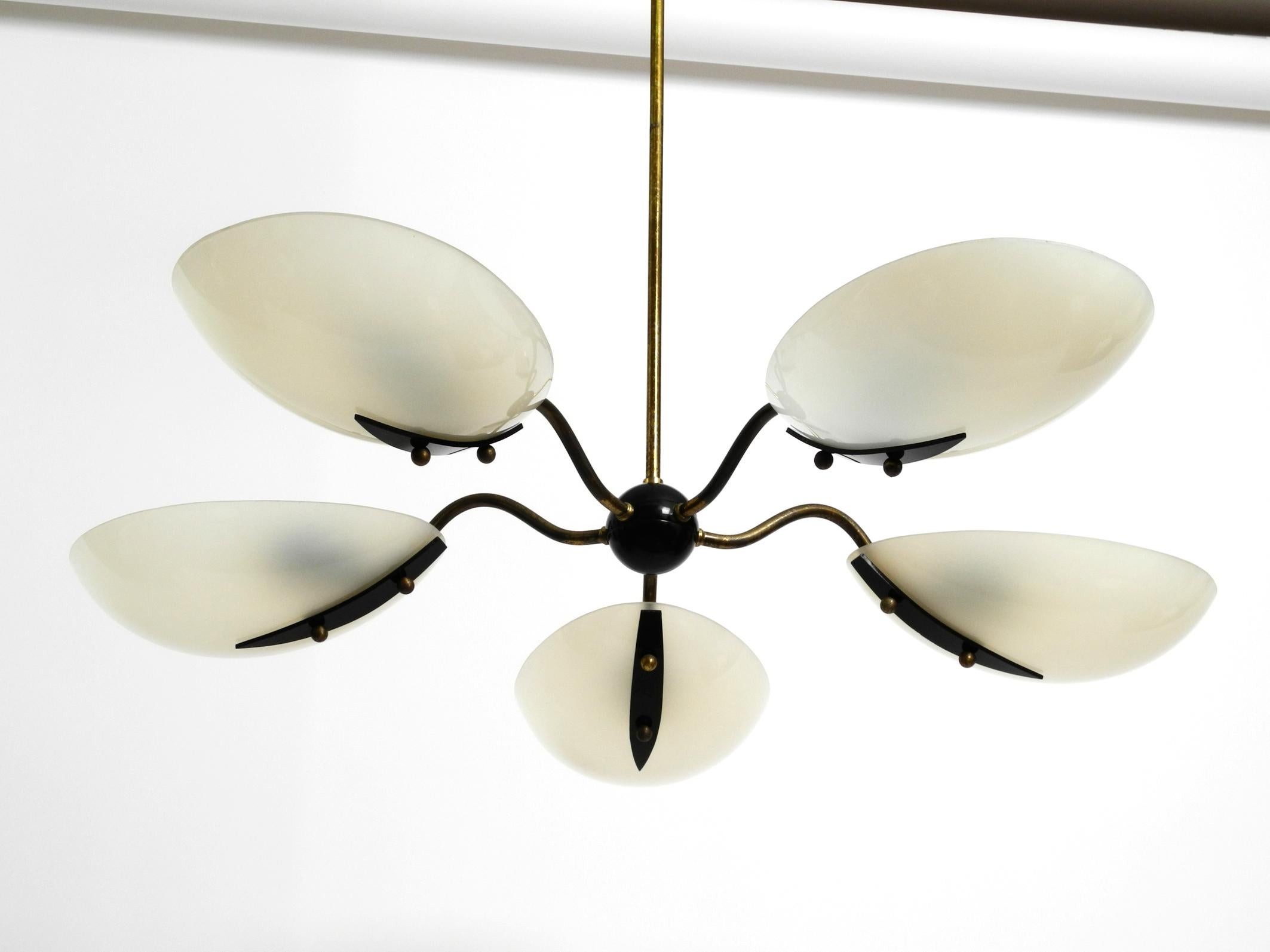 Gorgeous huge Mid-Century Modern brass chandelier with five arms 
made of brass and large plexiglass shades.
Extraordinary rare design with oval beige lampshades.
Five original brass E27 sockets for max 60W each.
100% original condition. In very