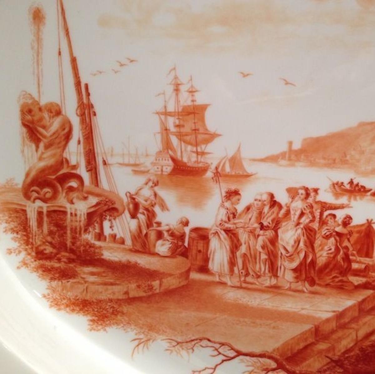Extraordinary large and beautifully painted platter. The painting in rust red camaieu style, extremely detailed and well done. Depicting some harbour scene with lots of figures.

Made in the 1930s (so called Pfeiffer period).

First choice.