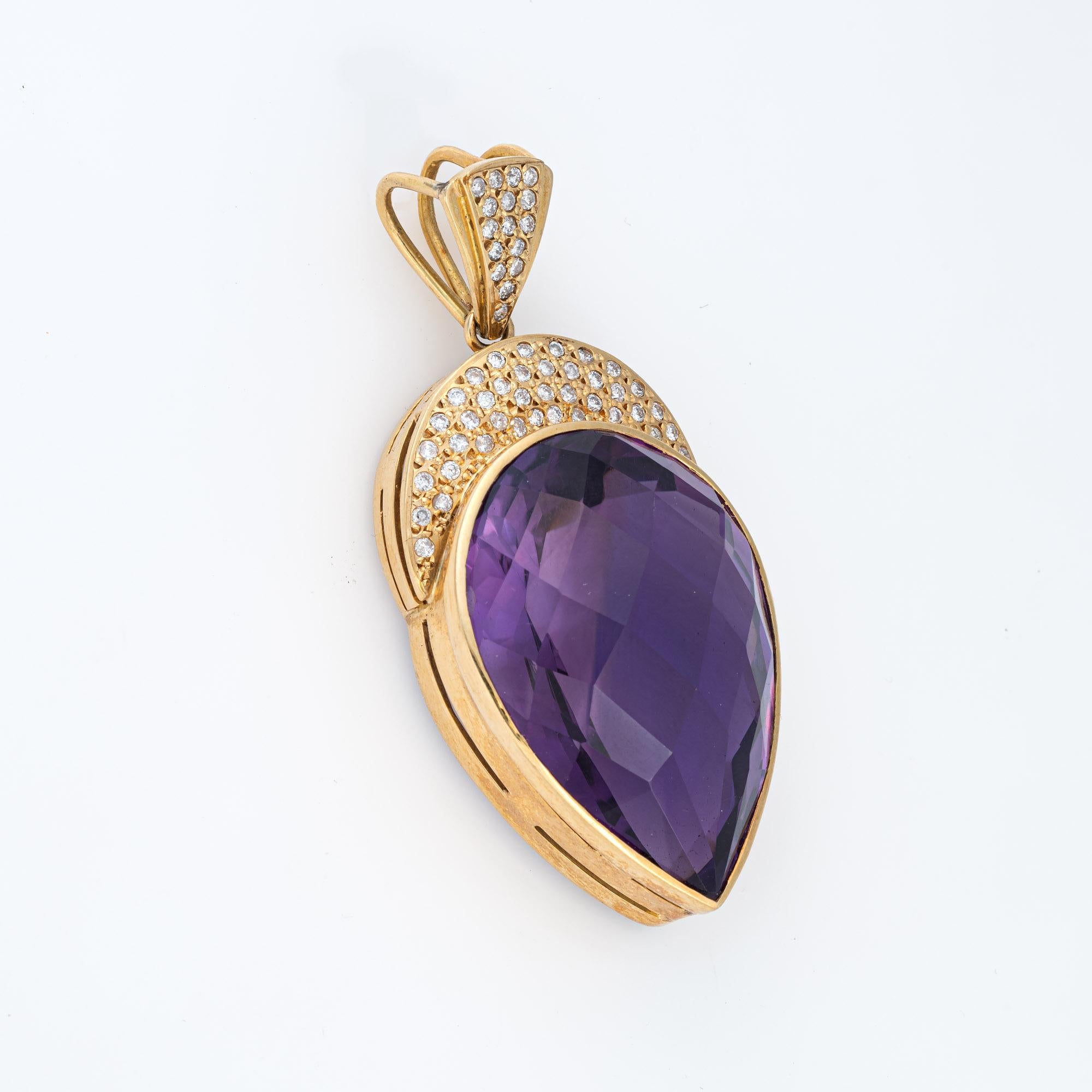 Finely detailed vintage amethyst & diamond pendant crafted in 14 karat yellow gold (circa 1970s). 

Pear cut amethyst measures 36mm x 26mm (estimated at 65 carats), accented with 56 small round brilliant cut diamonds totaling an estimated 0.56