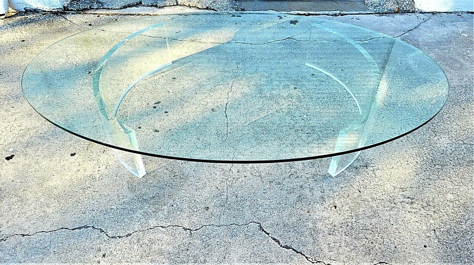 Offering one of our recent Palm Beach Estate fine furniture acquisitions of a
Mid-Century Modern dual curved Lucite pedestals & glass oval coffee cocktail table.

Approximate Measurements in Inches
12.75