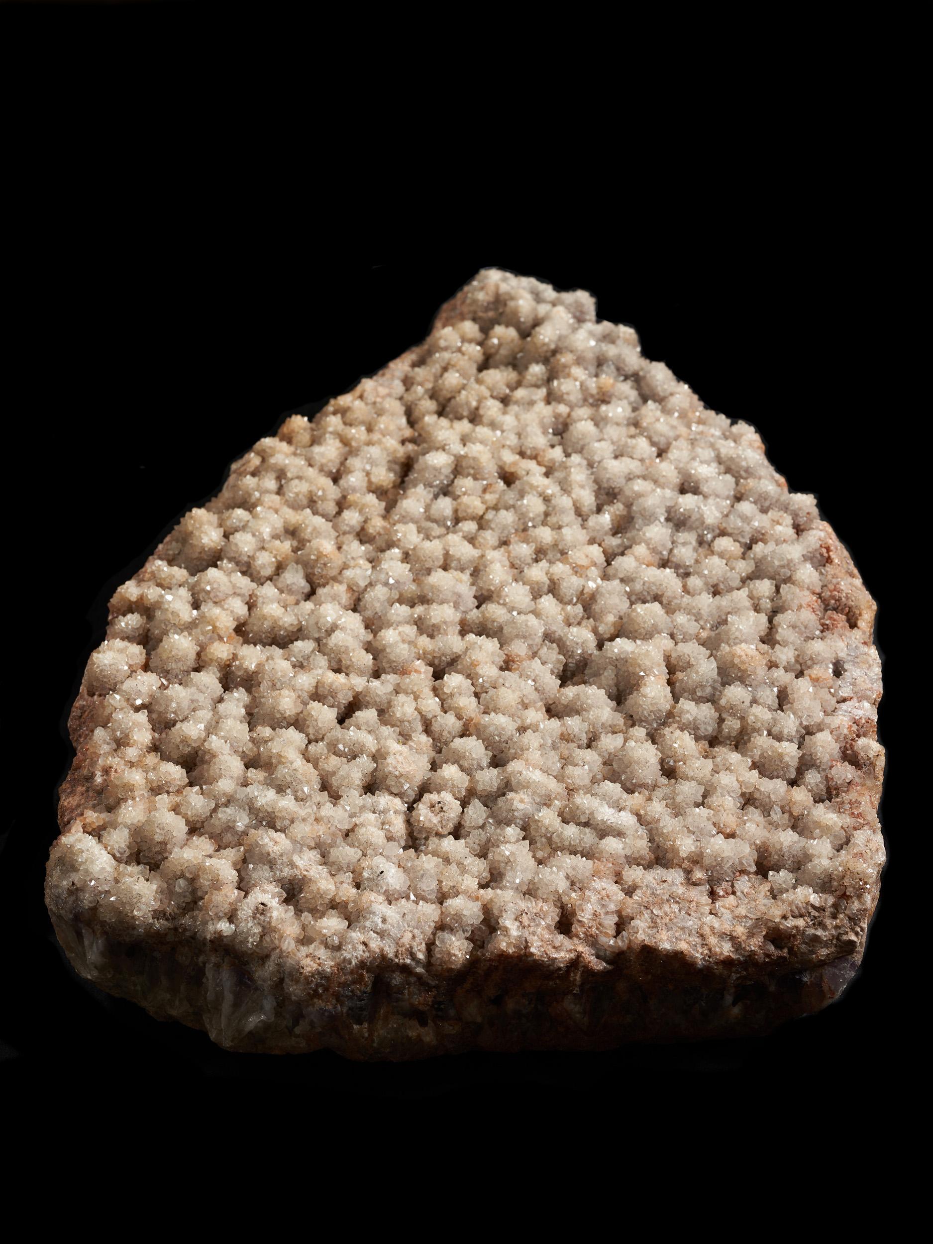 This Pinkish Quartz crystal covered rock either comes from India or the Himalaya mountains and weighs over 20 kg. Measures: 82 cm.