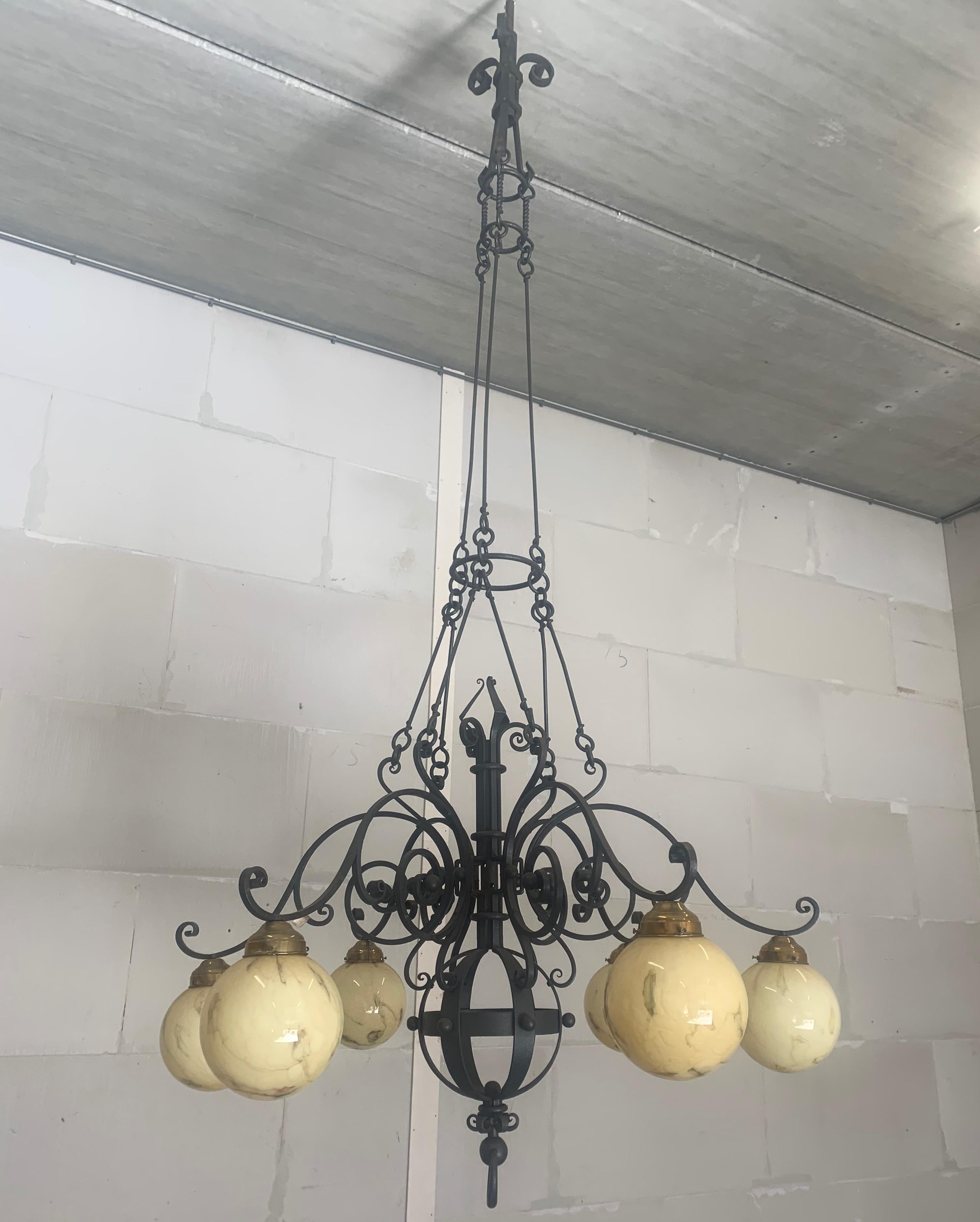 Enormous and all handcrafted, wrought iron light fixture has been hanging in a church.

Amazing quality and size chandelier. This forged in fire mega pendant is of incredible beauty and fit for a king. The size and quality of the workmanship makes