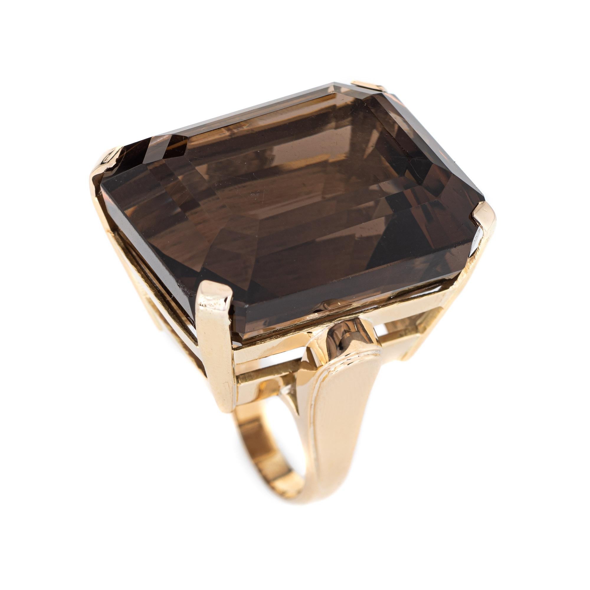 Stylish large estimated 93 carat smokey topaz cocktail ring (circa 1950s to 1960s) crafted in 14 karat yellow gold. 

Emerald cut smokey quartz measures 29.5mm x 24mm (estimated at 93 carats). The quartz is in very good condition and free of cracks