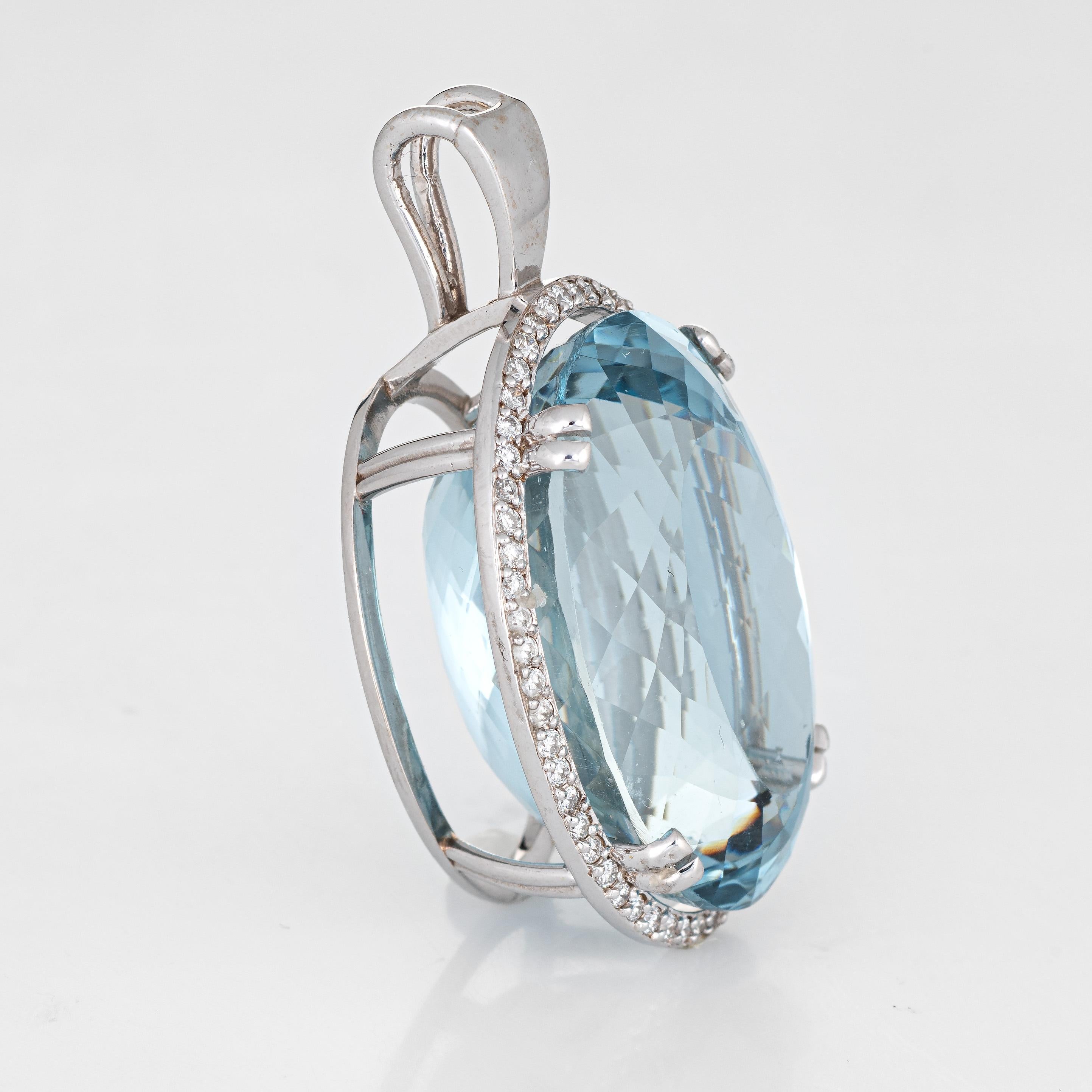 Finely detailed large blue topaz & diamond pendant crafted in 14k white gold.  

Faceted oval cut blue topaz measures 31mm x 22.5mm (estimated at 95 carats), accented with an estimated 1.12 carats of diamonds (estimated at H-I color and VS2-SI1