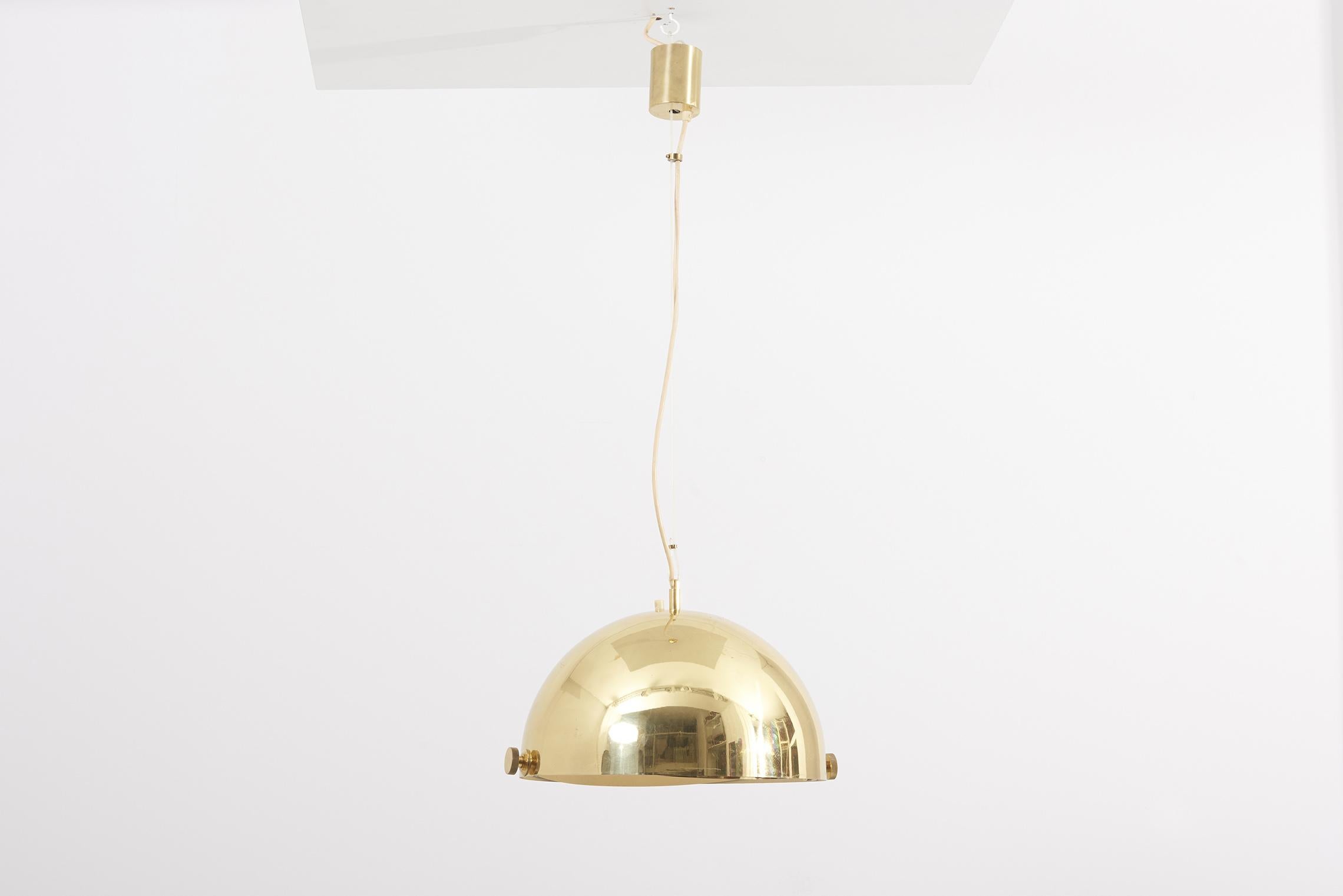 This huge brass pendant lamp with adjustable shade is attributed to Münchner Werkstätten, 1950s.
1 x E 27 bulb

Please note: Lamp should be fitted professionally in accordance to local requirements.
  