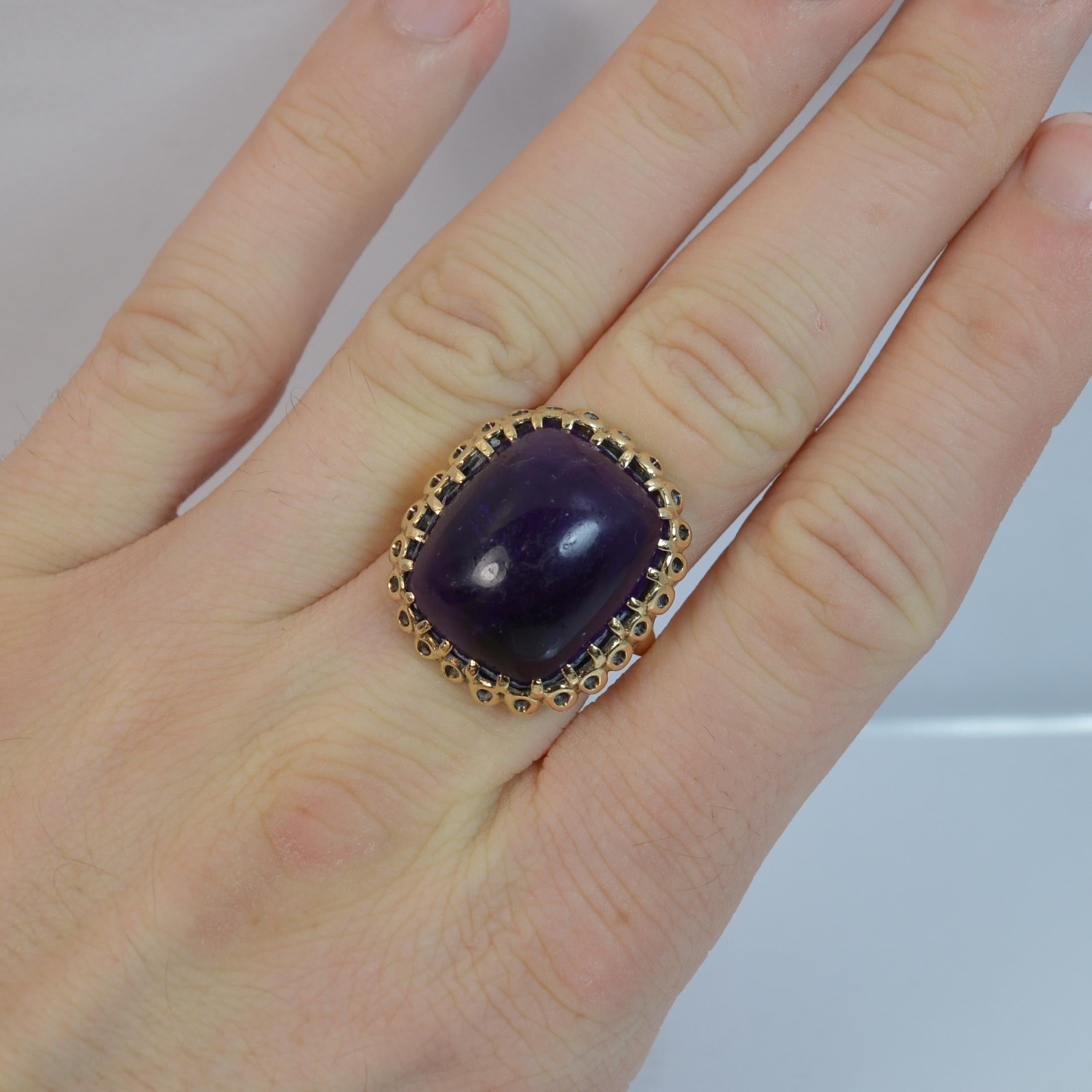 
A superb Amethyst and 9ct Gold ring.

​The natural amethyst is of a huge size, 17mm x 19mm head in claw setting. A very attractive cushion cabochon stone.

Solid 9 carat yellow gold shank and setting.

CONDITION ; Very good. Securely set amethyst.