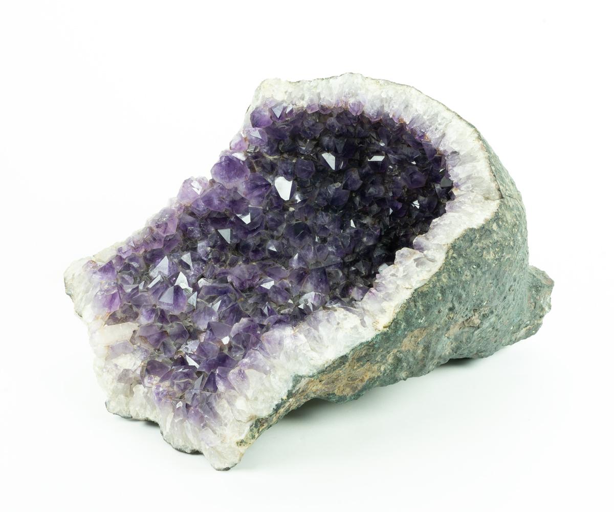 This is an excellent and quite large amethyst geode with large crystals that make it more rare than most crystals of this size. It rests well on a flat surface, thus it is easy to display.