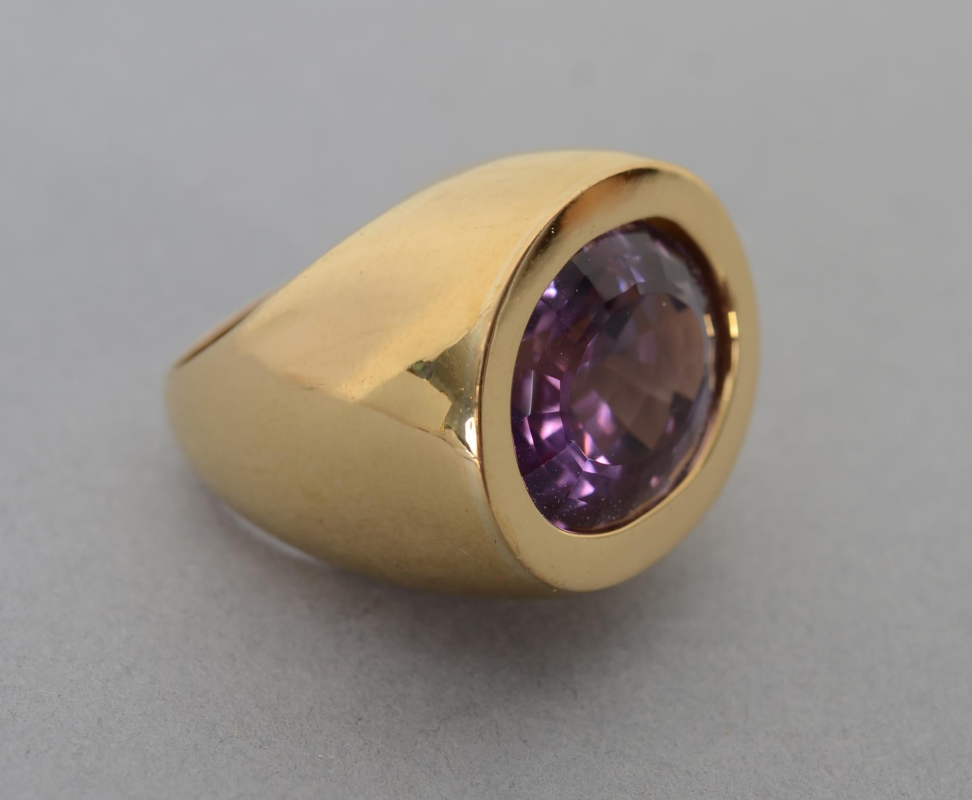 Powerful 18 karat gold ring set with a faceted amethyst of approximately 30 carats.The bezel is set horizontally. The face measures 13/16
