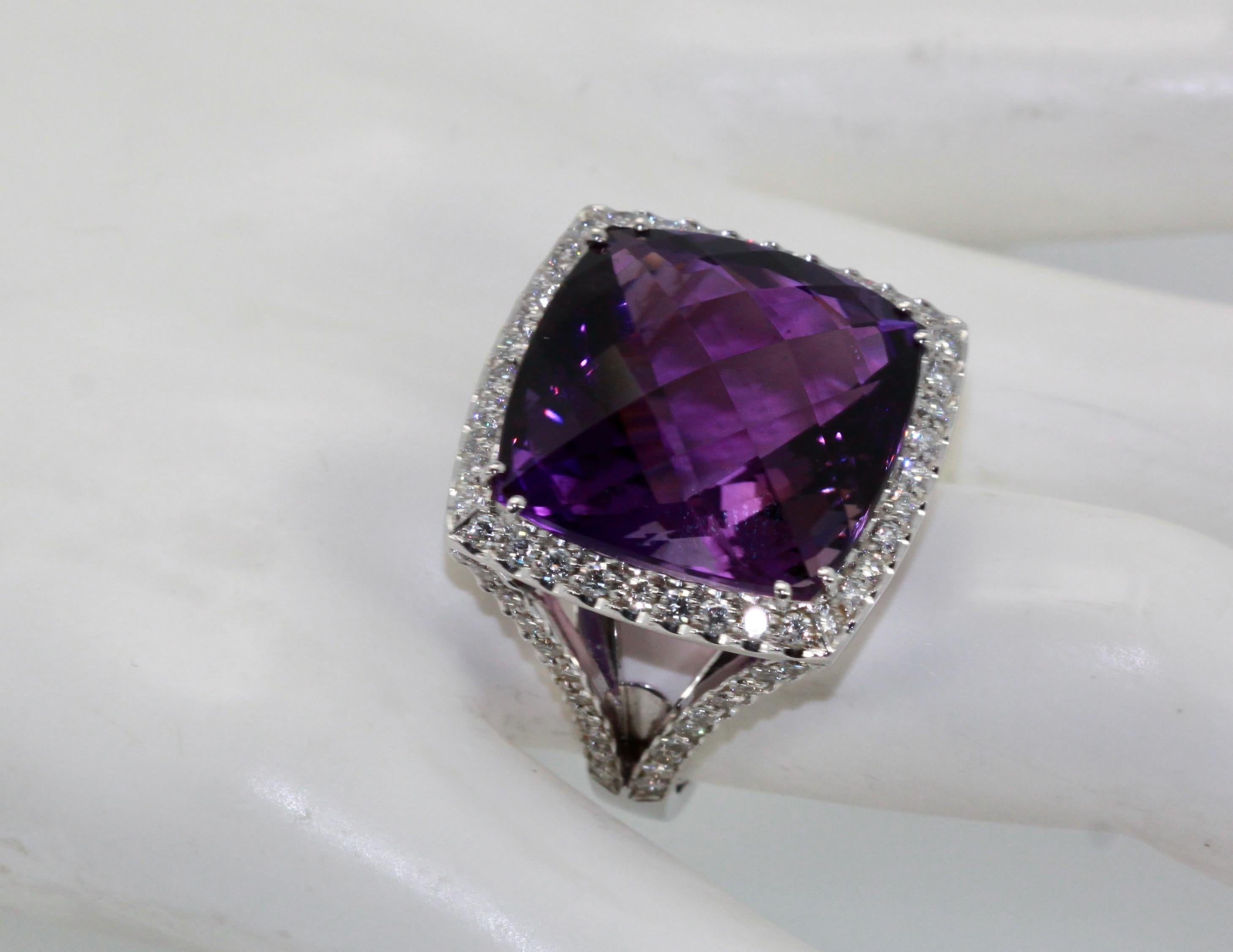 This huge Amethyst ring is 25 carats of a mixed cut Amethyst.  This ring has a Diamond border and also Diamonds down the shank.  Just arrived from Italy and is an amazing piece.  This Amethyst is a cushion cut and the Diamonds total 1.50 carats for