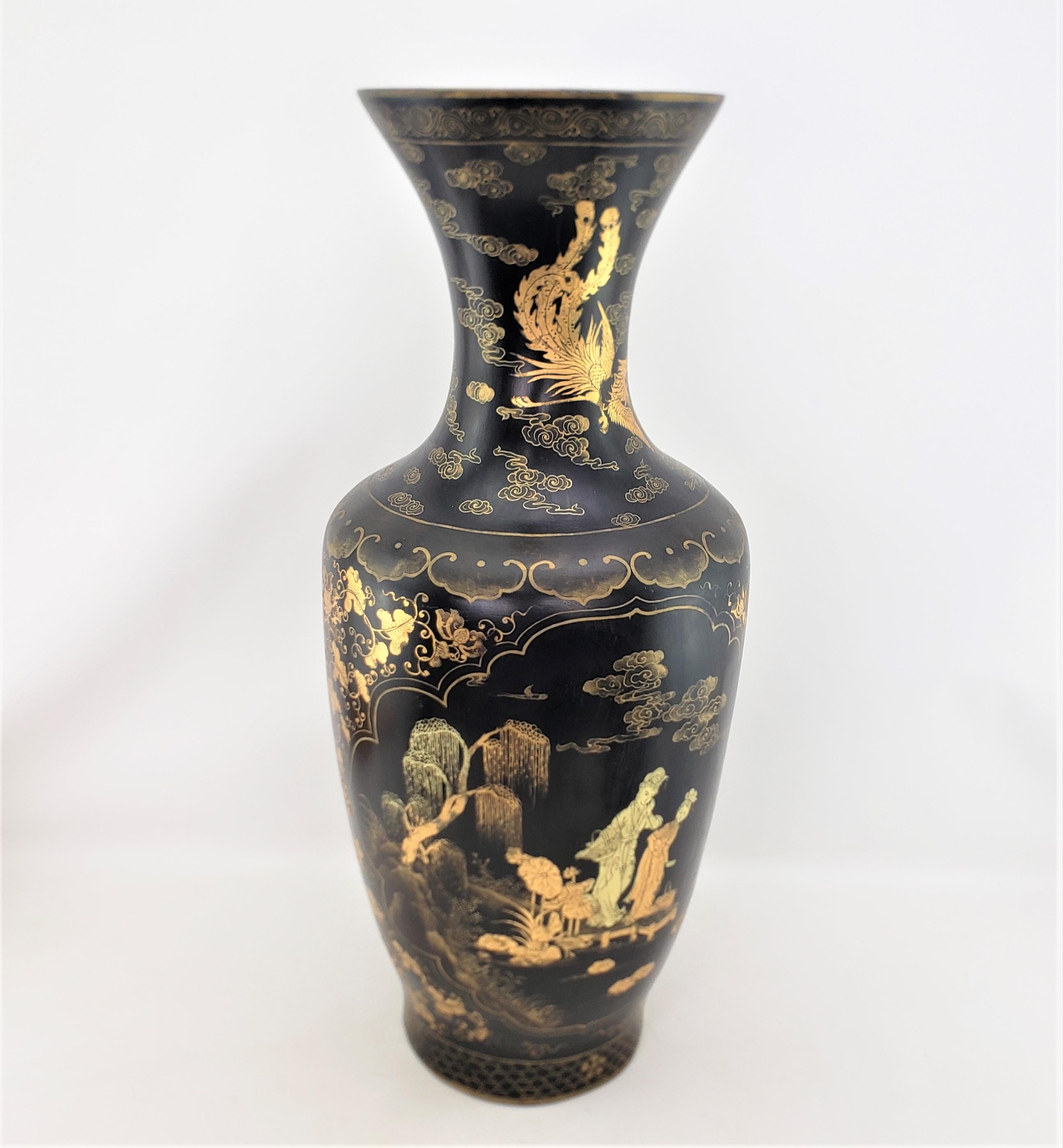 This large antique floor vase is unsigned, but presumed to have originated from China and date to approximately 1920 and done in a period Chinese Export style. The vase is composed of paper mache with a black lacquer ground with hand-painted gilt