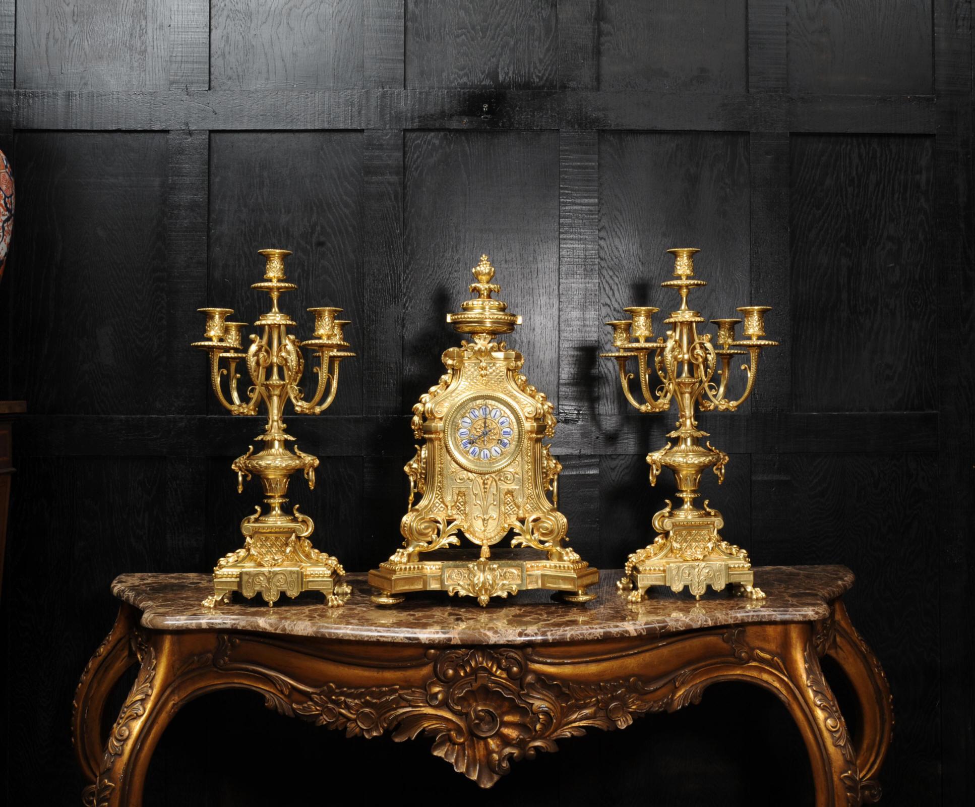 A very large and beautifully detailed and finished original antique French clock set by Barrard & Vignon of Paris, circa 1880. It is Baroque in style, standing on a base with hairy paw feet, on scroll brackets, reeded corner columns supporting the