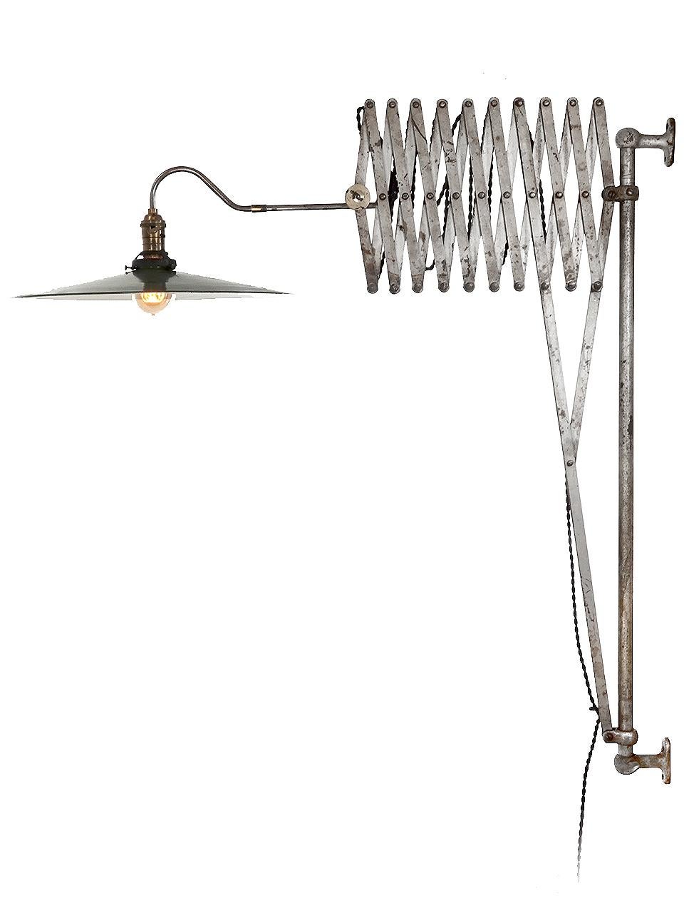 We have offered a quite a few lamps over the years but nothing like this. It must be the most interesting scissor lamp I have seen. It swings side to side on a 38 in tall wall bracket and can lock in place with a thumb screw. The scissor extends to
