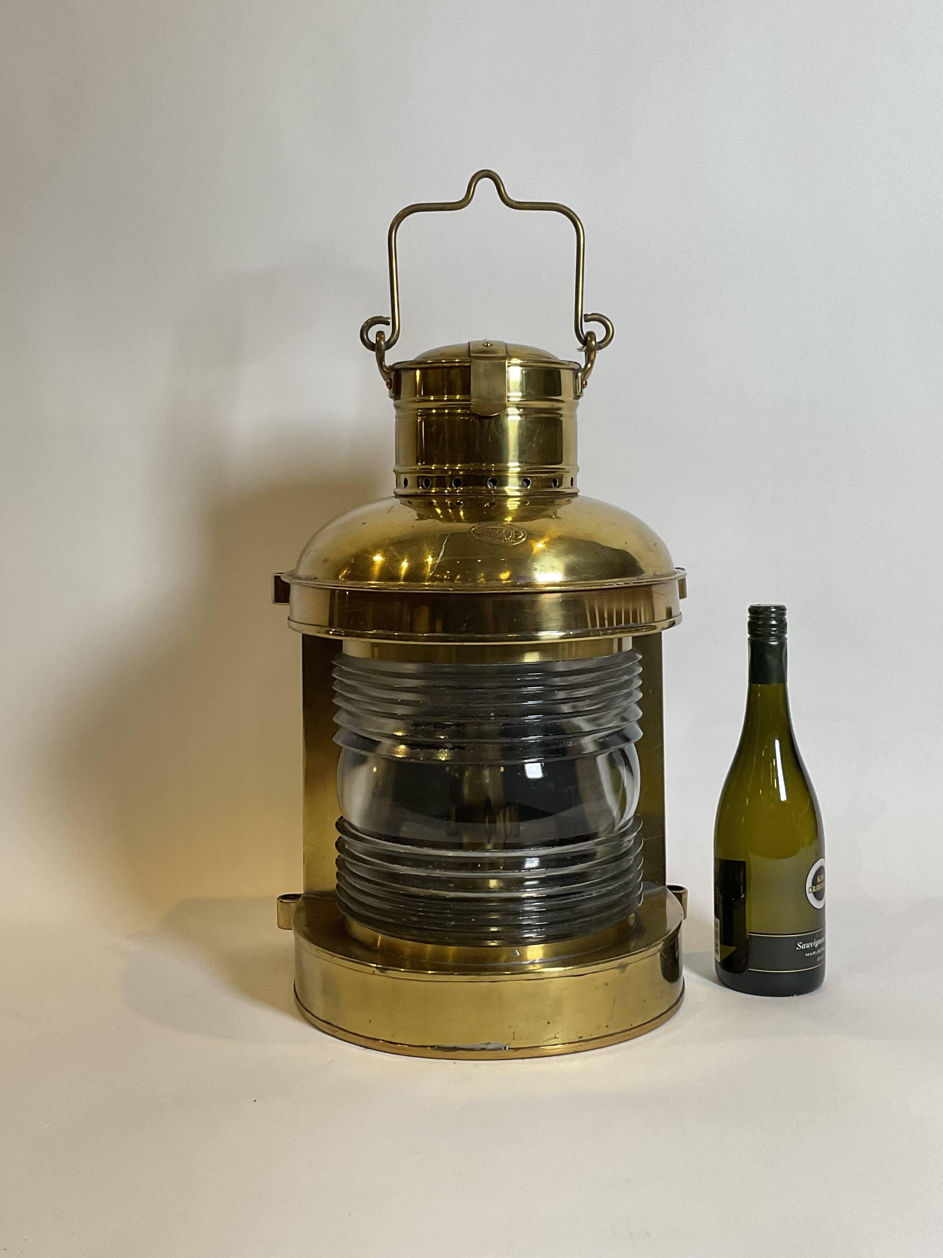 made by Perkins Marine Lamp Corporation of Brooklyn, New York. Fitted with a glass fresnel lens. Old lacquered finish. With original burner and tank.

Weight: 22 lbs.
Overall Dimensions: 20