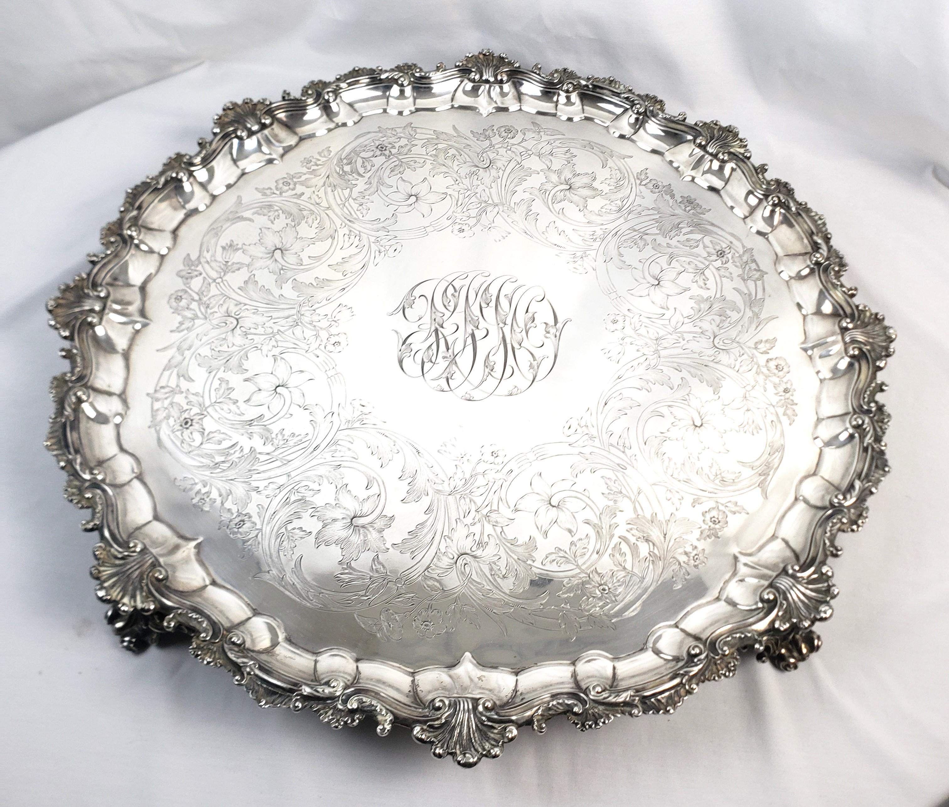 This enormous and very substantial antique salver or footed tray was made by Hunt, Roskell, Tate, Storr and Mortimer of England and dates to 1865 and done in the period Victorian style. This significant antique salver is composed of solid sterling