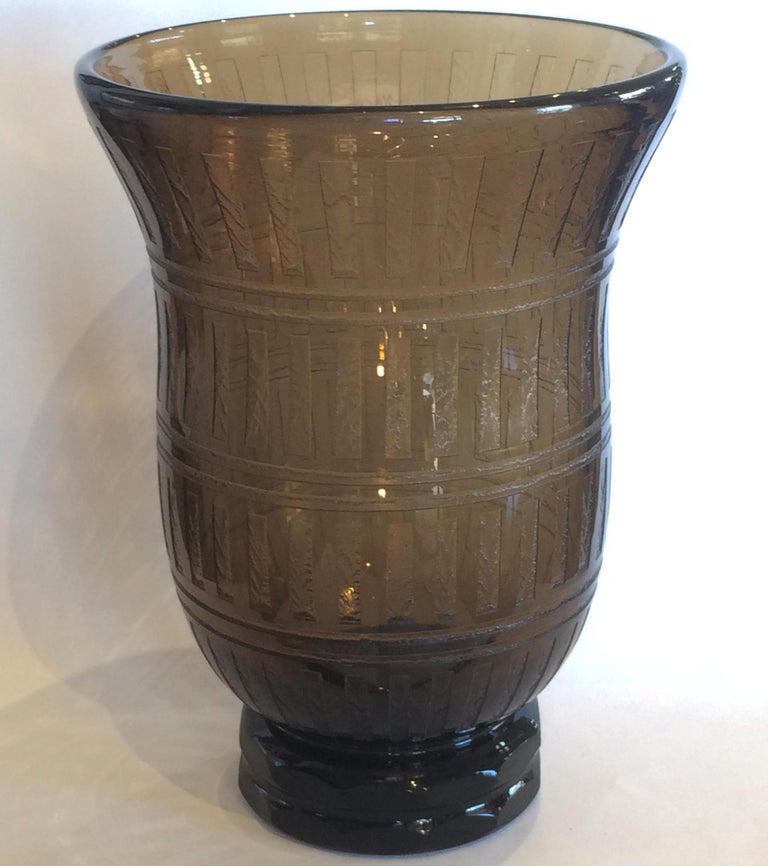 Art Deco, huge vase by Daum, of Nancy, France. This vase is in the “smoke” color, and has a stepped base. It is very “Deco geometric” with the double base rings, facetted into 12 polished sides to each level; the upper area has 3 horizontal,