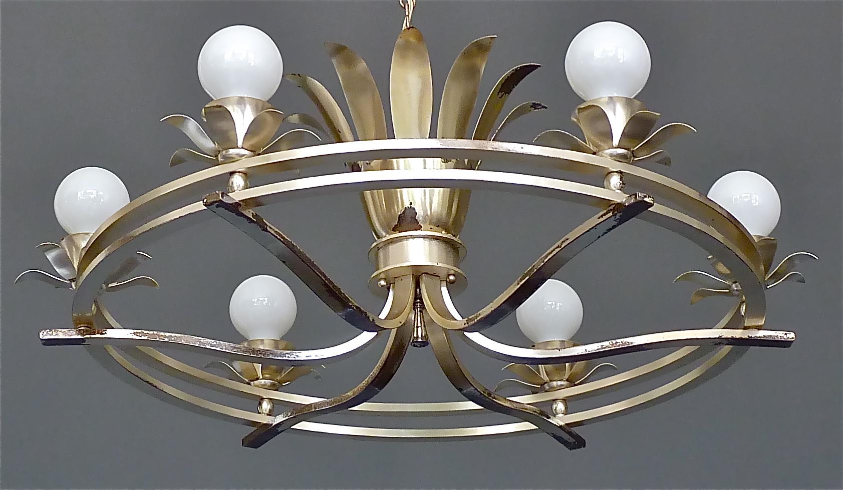 Huge elegant Art Deco chandelier with lovely leaf and flower details designed and executed in France in the 1930s. The silvered brass metal chandelier which originates from a Villa in Luxemburg is 80 cm / 31.50 inches tall and has a width of 85 cm /