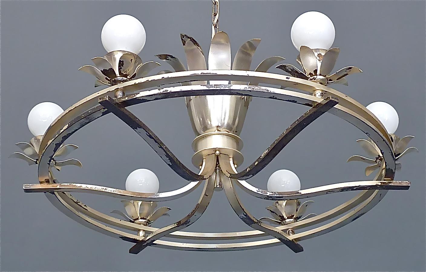 Huge elegant Art Deco chandelier with lovely leaf and flower details designed and executed in France in the 1930s. The silvered brass metal chandelier which originates from a Villa in Luxemburg is 80 cm / 31.50 inches tall and has a width of 85 cm /