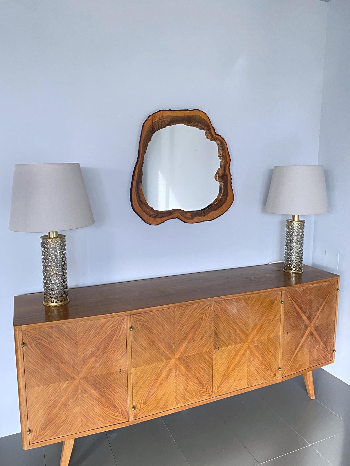 Beautiful walnut wood slab mirror in the style of Carl Auböck, handmade in 1956, Austria. The mirror is an eye-catcher in a modernist but also a country style house. On the backplate are four mounting holes for individual hanging.

 