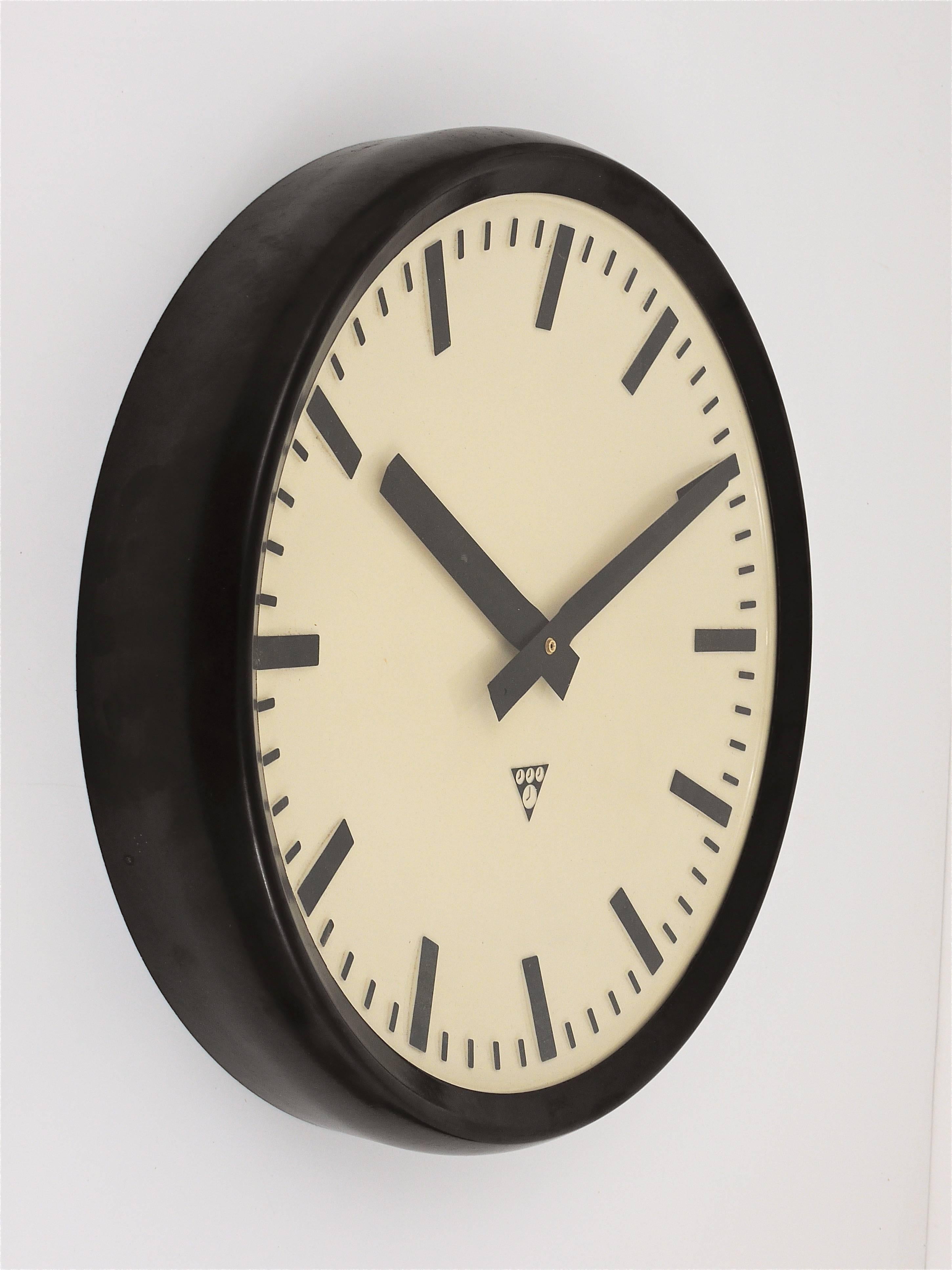 Une grande horloge murale de loft ou industrielle des années 1940. Un design droit et magnifique, avec un cadran d'horloge bombé, le boîtier est fait de Bakélite brun foncé / noir. Mesures : 19 pouces de diamètre. Alimenté par un mouvement à quartz,