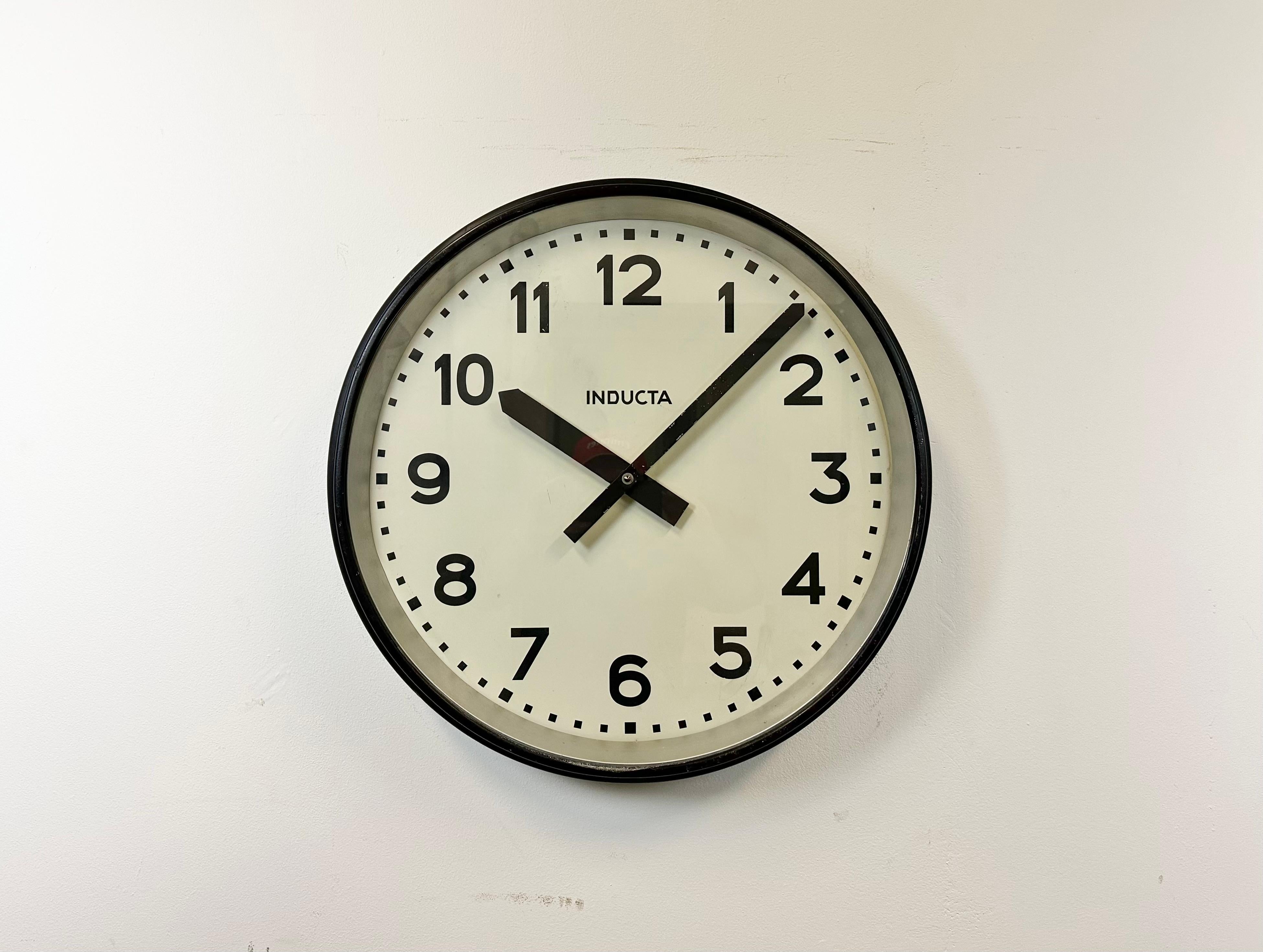 This wall clock was produced by Inducta in Switzerland during the 1960s.It features an aluminium body, a metal dial and a clear glass cover. The piece has been converted into a battery-powered clockwork and requires only one AA-battery.
The