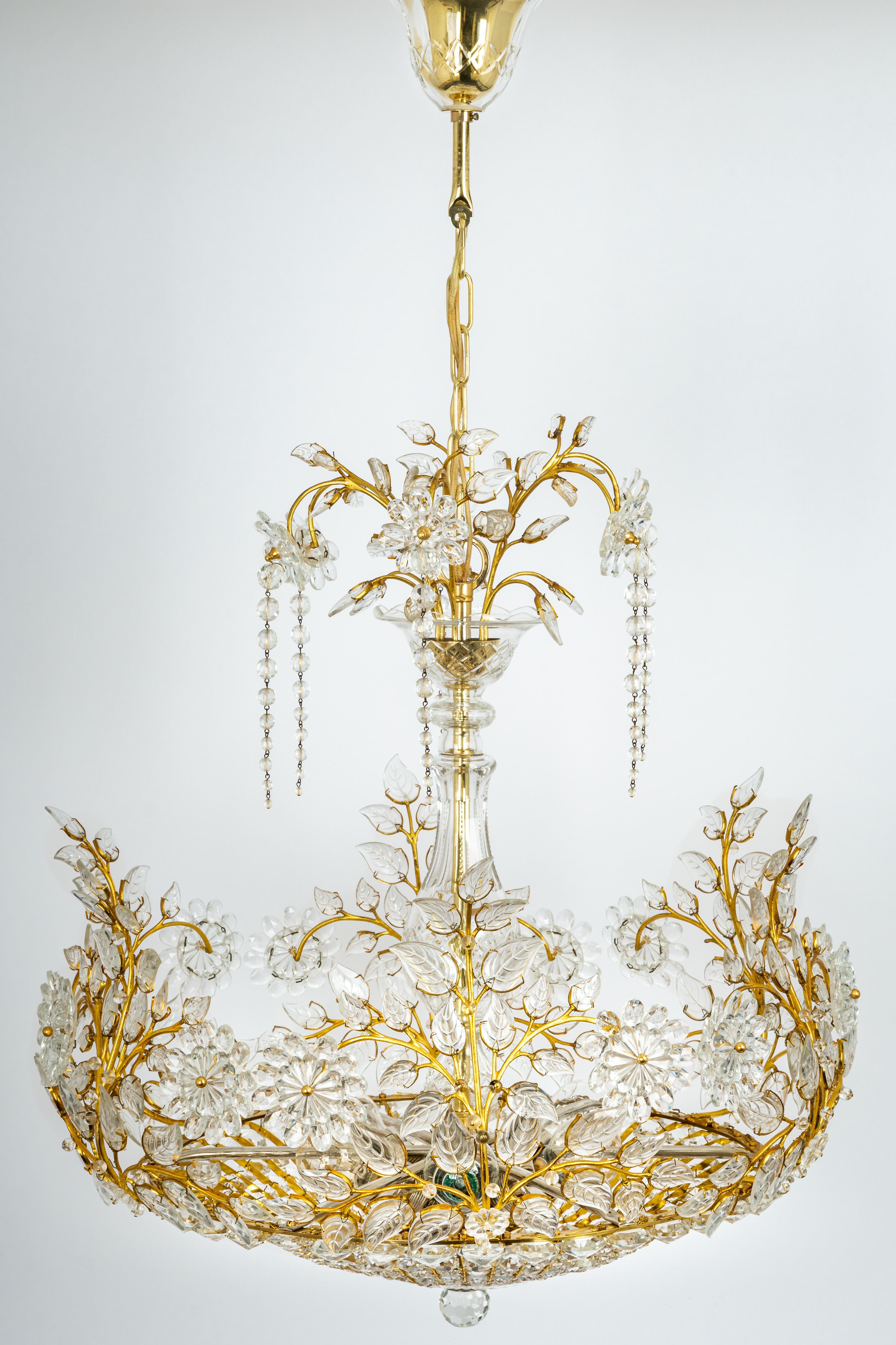 A wonderful and high-quality brass chandelier by Palwa, Germany, 1970s.
It is made of a brass frame and many crystals. Great scale and exquisite detail.2 small glasses are missing.

The lamp takes 6 x E27 (standard Bulbs up to 60 Watts