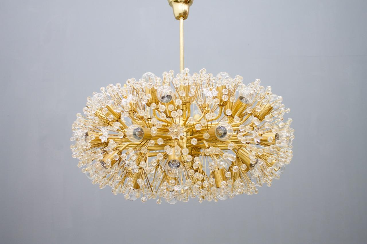 A beautiful and large brass and glass chandelier from the 1960s in a good condition. 

Measures: Diameter 73 cm (28.7 inches), height without the chain is 42 cm (16.5 inches) with the chain 70 cm (27.5 inches). The chain can be shortened.

    