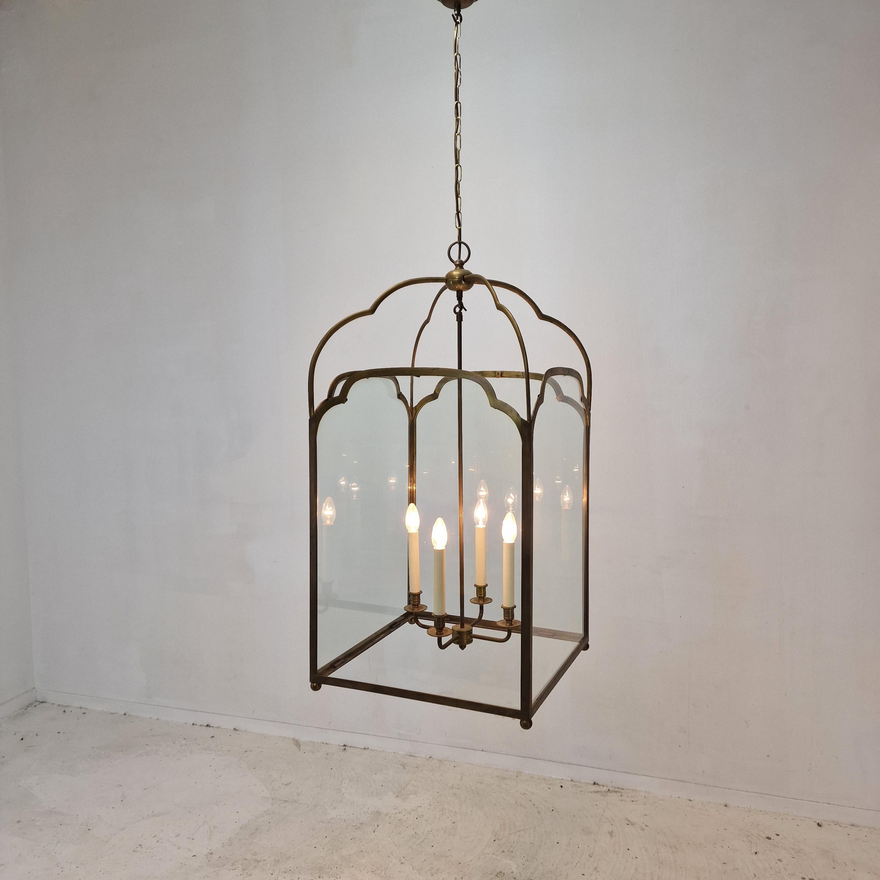 Amazing and very large French hall lantern, early 20th century.

Step back in time to the elegant era of Regency with this exquisite 20th century brass lanterns, a tribute to the refined tastes and architectural splendor of the period. 
Inspired by