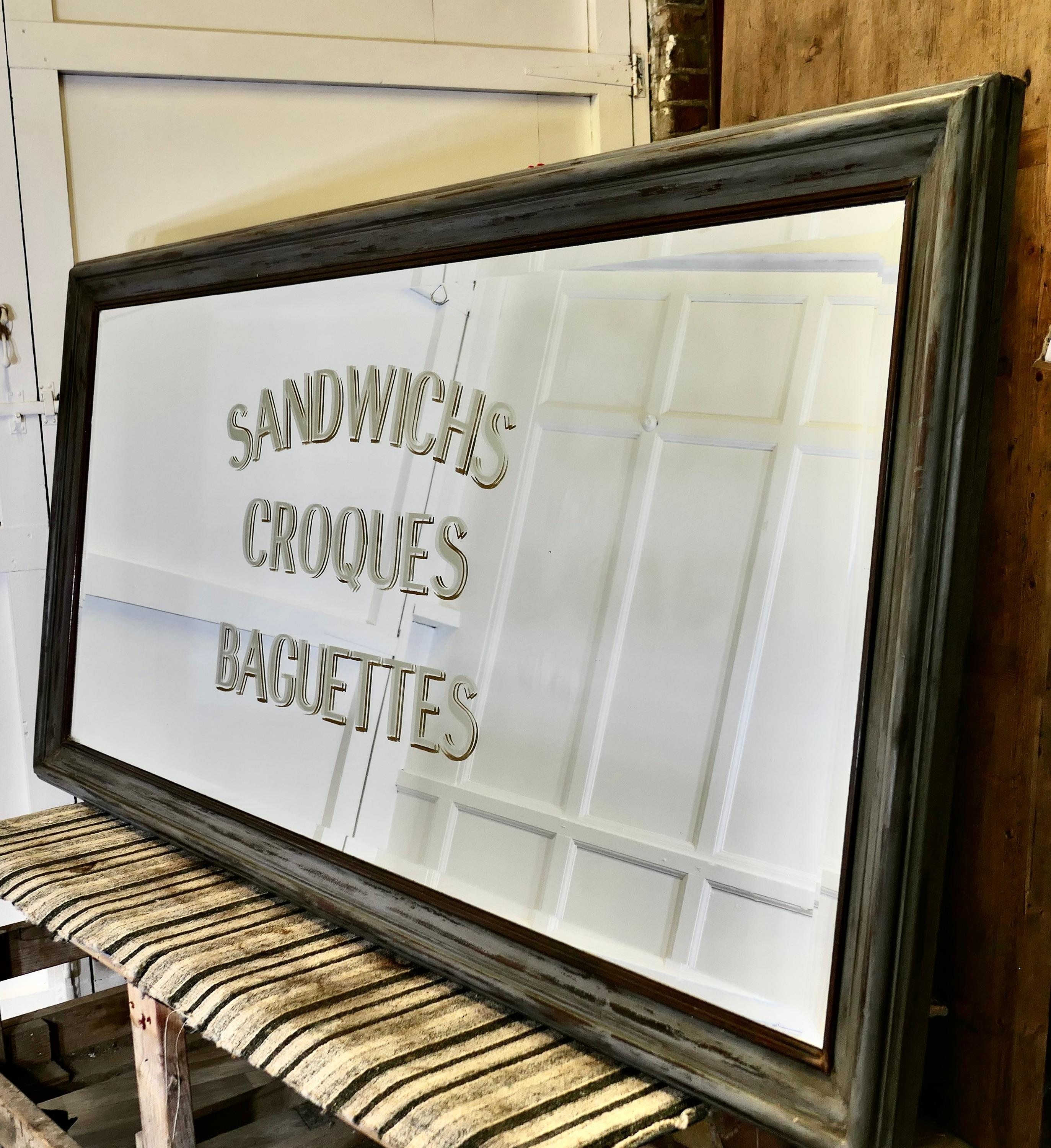 Huge Brasserie Advertising Mirror, Sandwiches Croques & Baguettes

This is a Huge piece the bevelled mirror is set in a 4” wide frame, in the centre in large letters in gold leaf and etched into the glass it is advertising “Sandwiches Croques &
