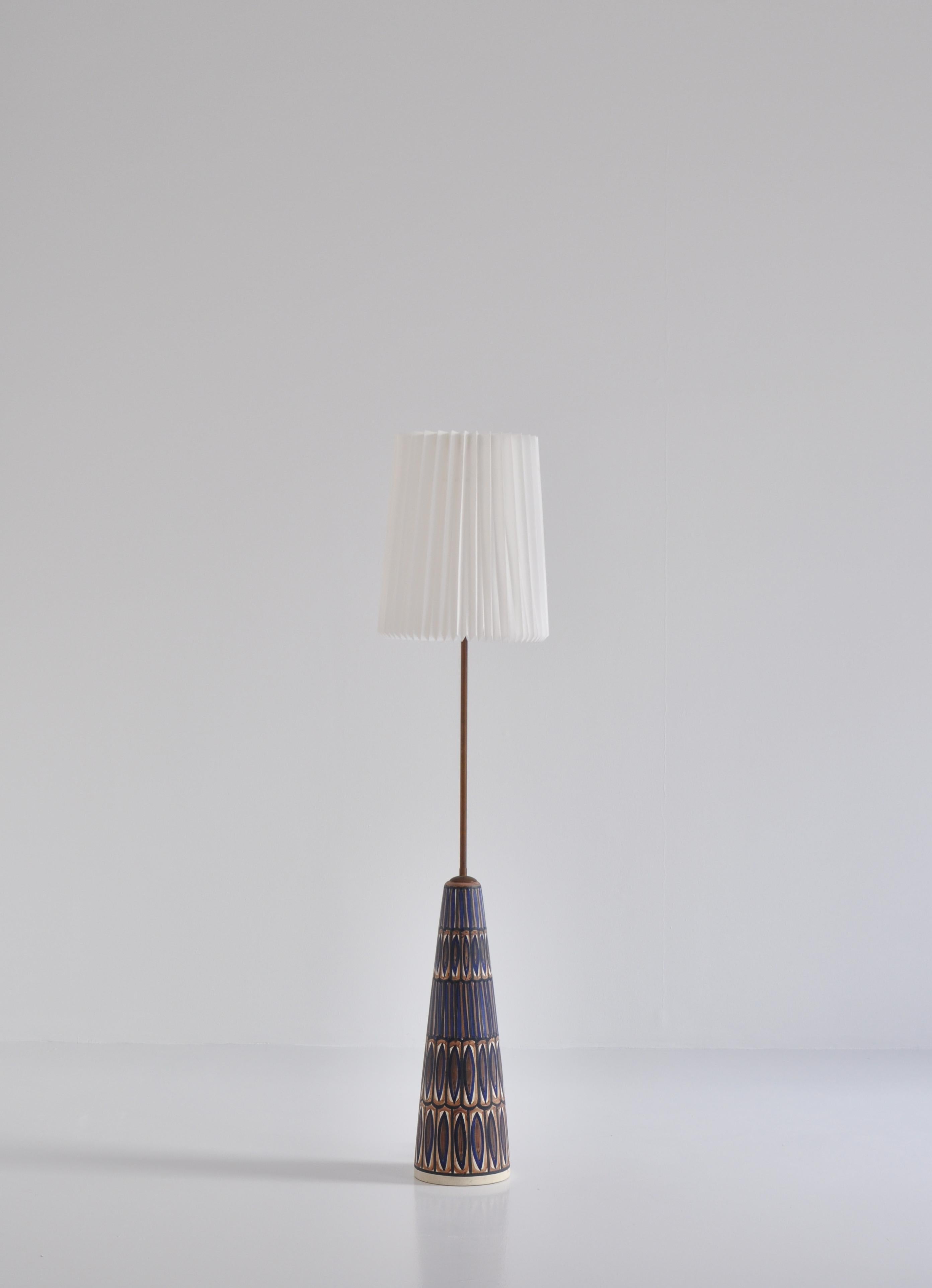 Hand painted floor lamp from the 1960s by Danish artist Noomi Backhausen at Søholm ceramics workshop, Bornholm. The lamp has been mounted with a new hand folded acrylic Le Klint shade.
Each of these rare lamps were made by hand and are unique in