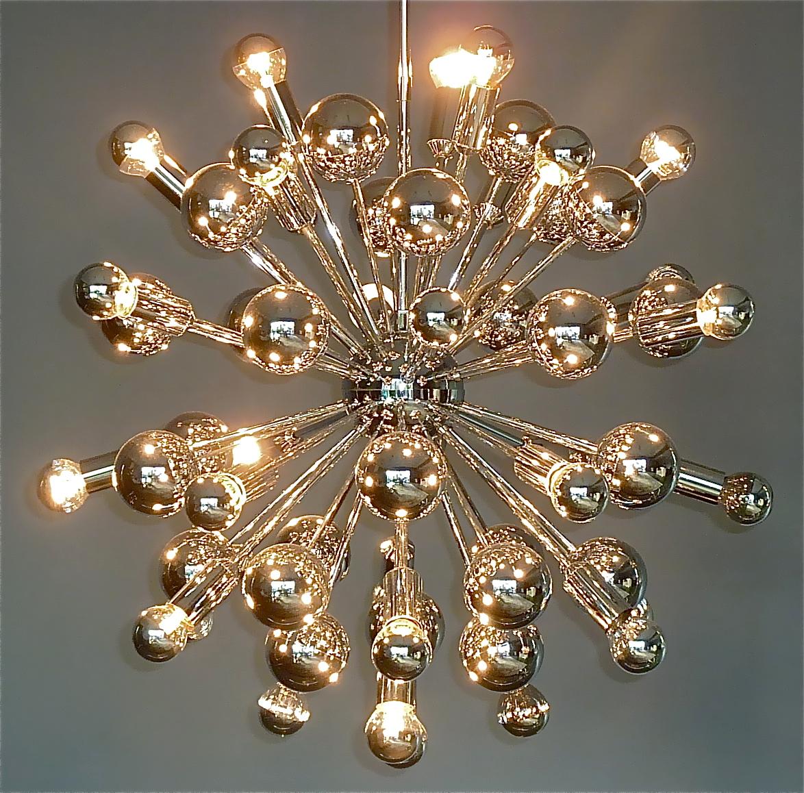 Gorgeous huge 1960s to 1970s chrome brass metal sputnik style light fixture in atomic star burst shape with chrome ball ends and 31 light sockets. The spectacular Italian or German orbit light sculpture in Stilnovo Style is 104 cm / 40.94 inches