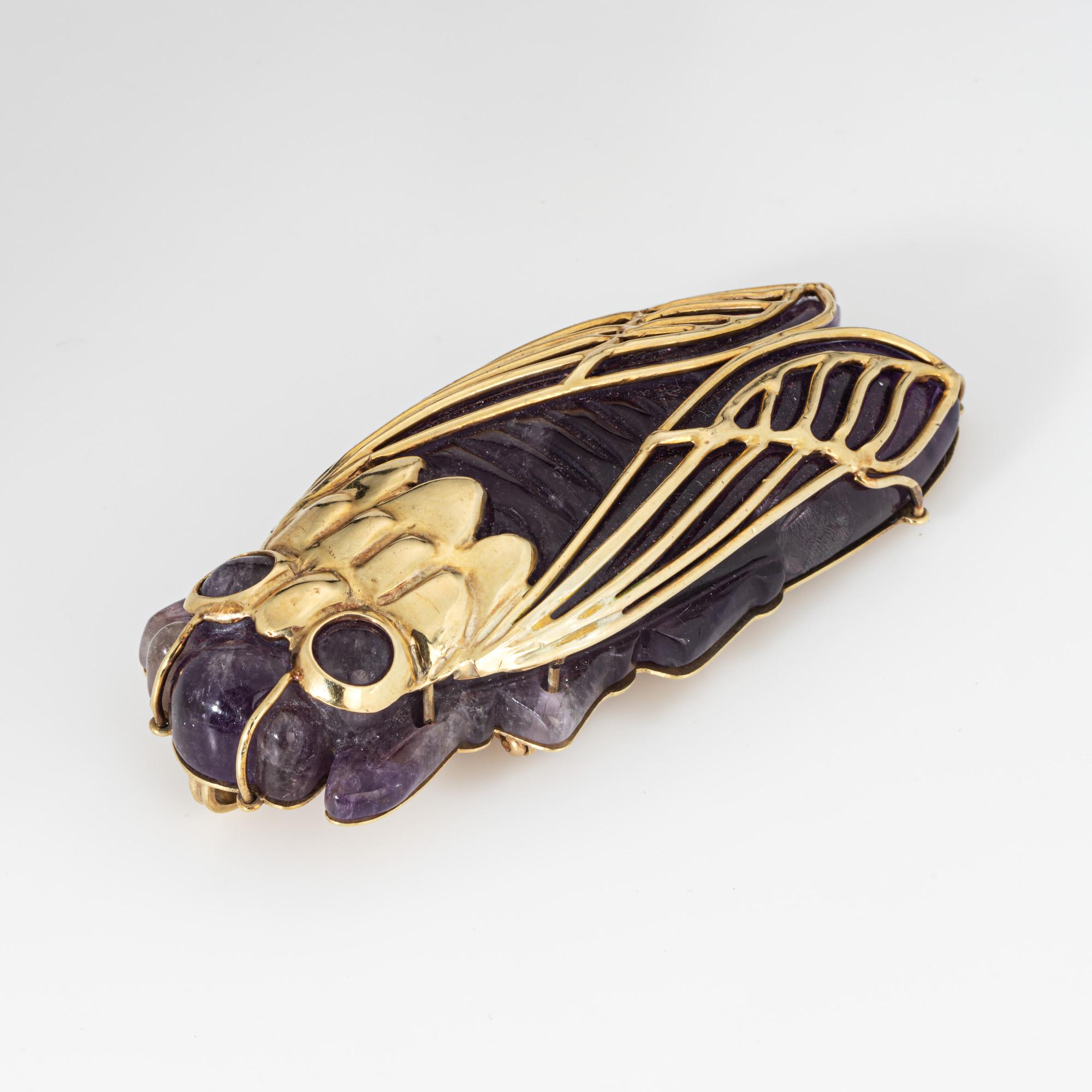 Distinct vintage large carved amethyst Cicada pendant crafted in 14k yellow gold (circa 1960s).  

Carved amethyst measures 2 3/4 x 1 1/4.  

This extraordinary vintage pendant features a stunningly large and oversized design, centering on an
