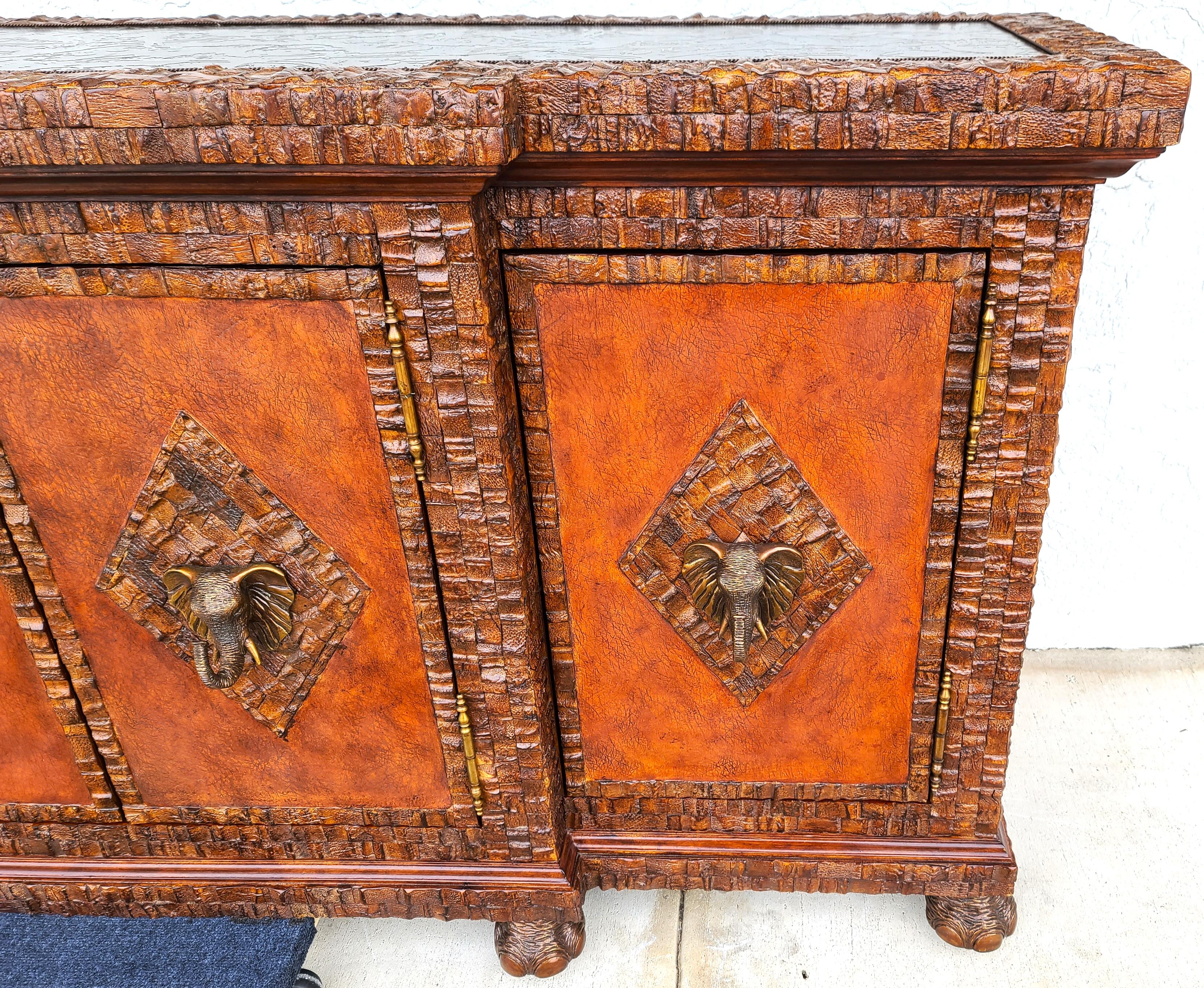 Offering One of our recent palm beach estate fine furniture acquisitions of a
Huge coconut shell, brass elephants & brass top bar cabinet by lloyd buxton
Finished entirely of coconut shell, with solid brass elephant door handles and feet, and a