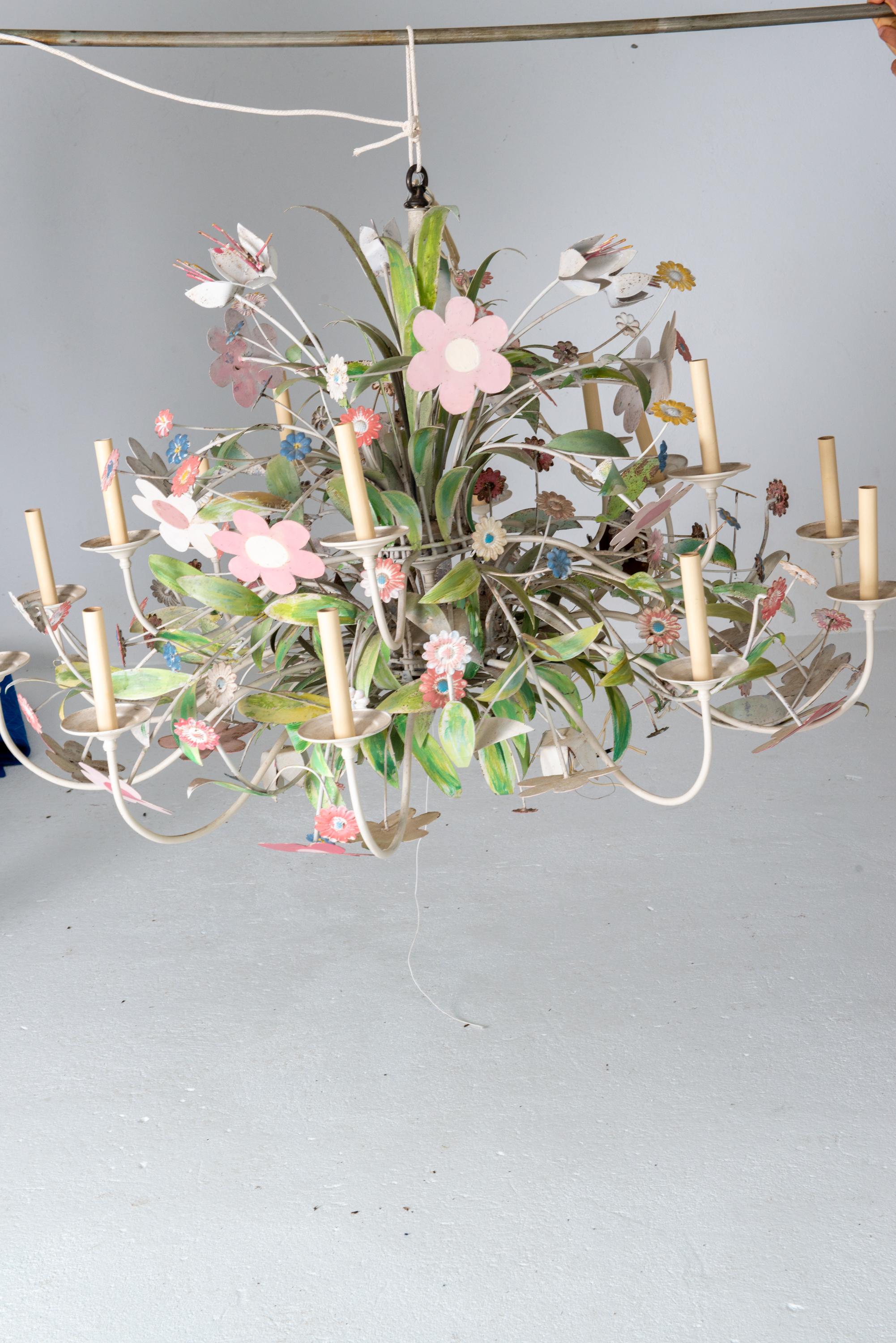 A one of a kind, custom made huge metal floral chandelier with multiple variety of flowers. A whimsical, playful massive chandelier. Great in a light hearted dining room, a playroom, a pool house, a child's room. Use your imagination. More than a