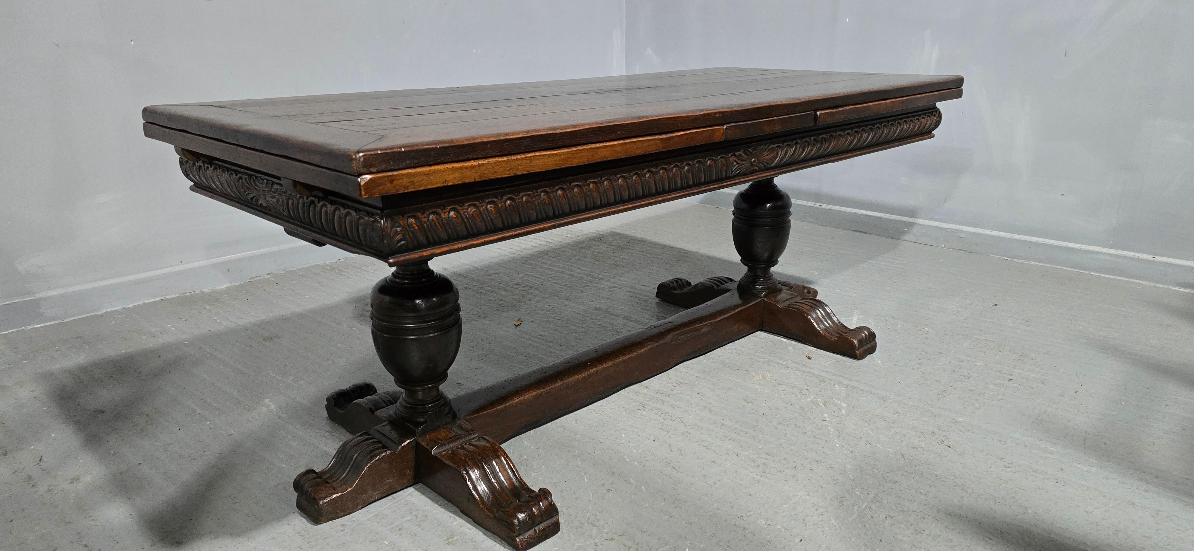 A superb huge Elizabethan style extending draw leaf double pedestal oak dining table, 2 inch thick top, peg jointed throughout, carved freize, lovely home ready condition.

30