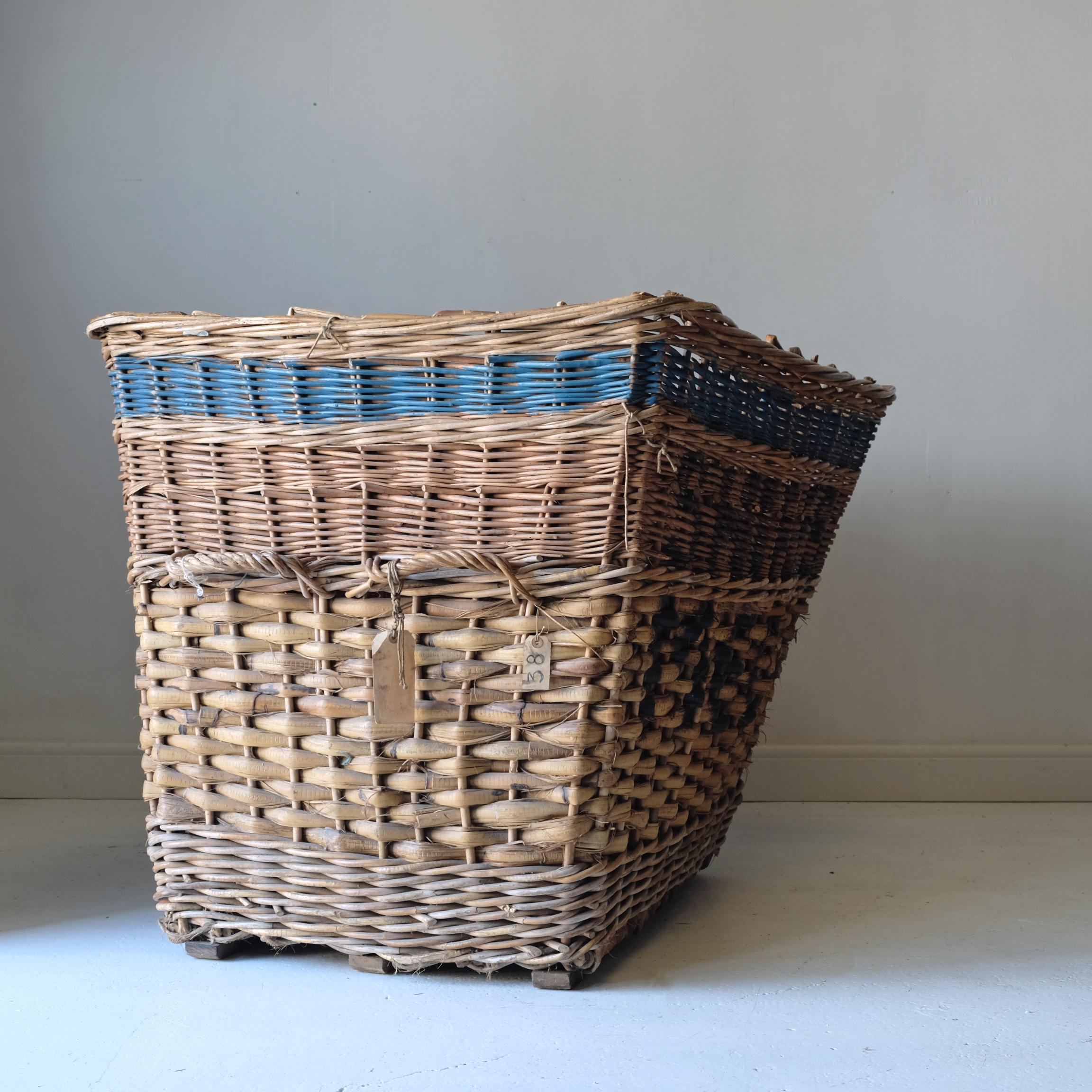 A huge early 20th century Industrial mill basket, originally from James Shires & Sons of Huddersfield, established in 1864. With a wonderfully characterful misshapen appearance from years of abuse in an Industrial setting, the basket remains solid