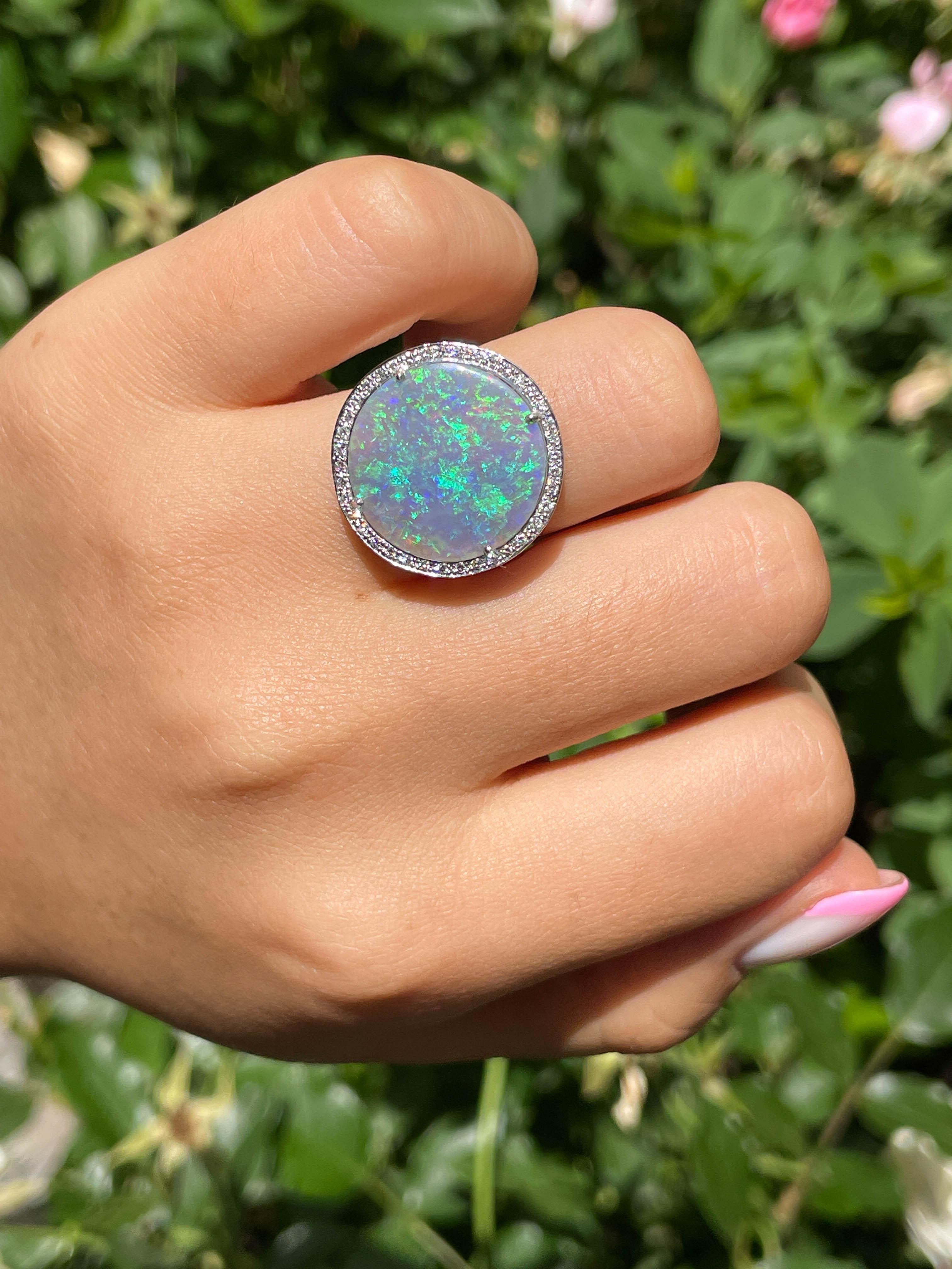 This Beautiful Vintage Australian Crystal Opal is set in Authentic GRAFF Platinum Ring, signed “GRAFF”. The Center Stone is Round Shape Cabochon Australian Crystal Opal. Simply Stunning! Gorgeous Array of All the Colors, weighing 4.70ct (estimated),