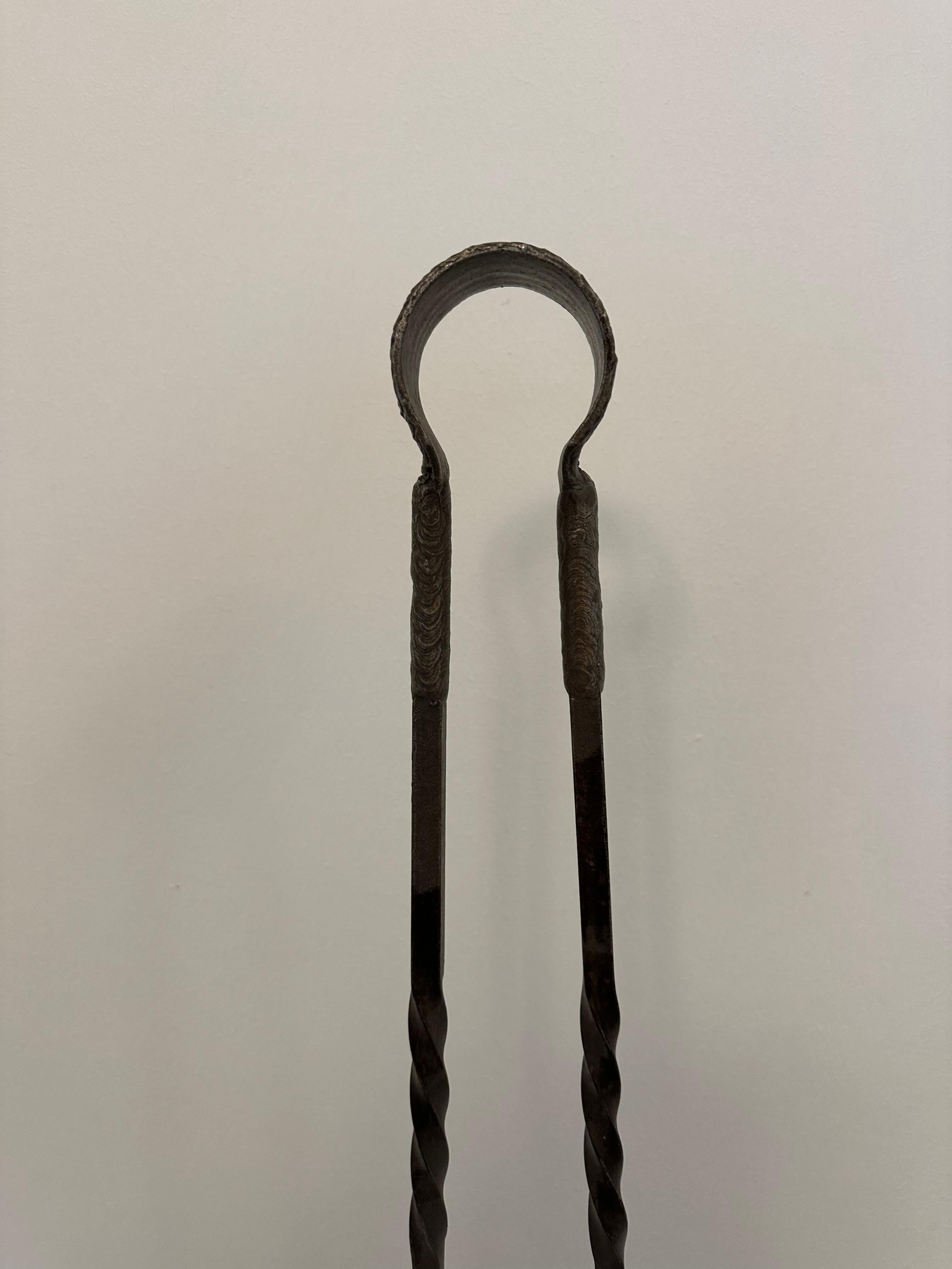 Huge 30.1 inch tall unusual hinged fire tongs.

Great decorative piece, very sturdy and suitable for handling big fire logs.
