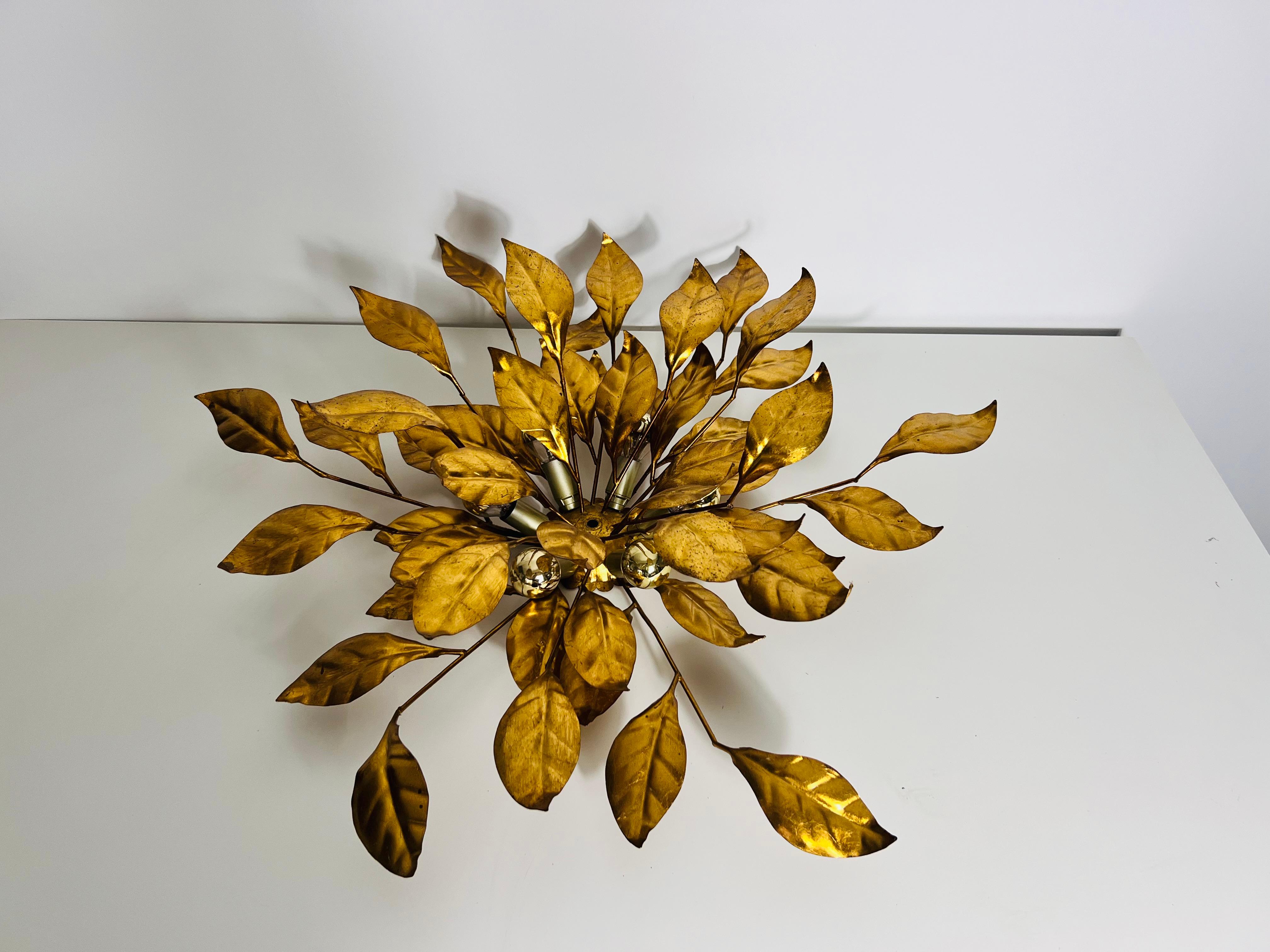 An extraordinary wall lamp by Hans Kögl, crafted in Germany in the 1950s, epitomizes the elegance and charm of the Hollywood Regency era. This exquisite lamp features a beautiful flower design, meticulously crafted to capture the delicate details