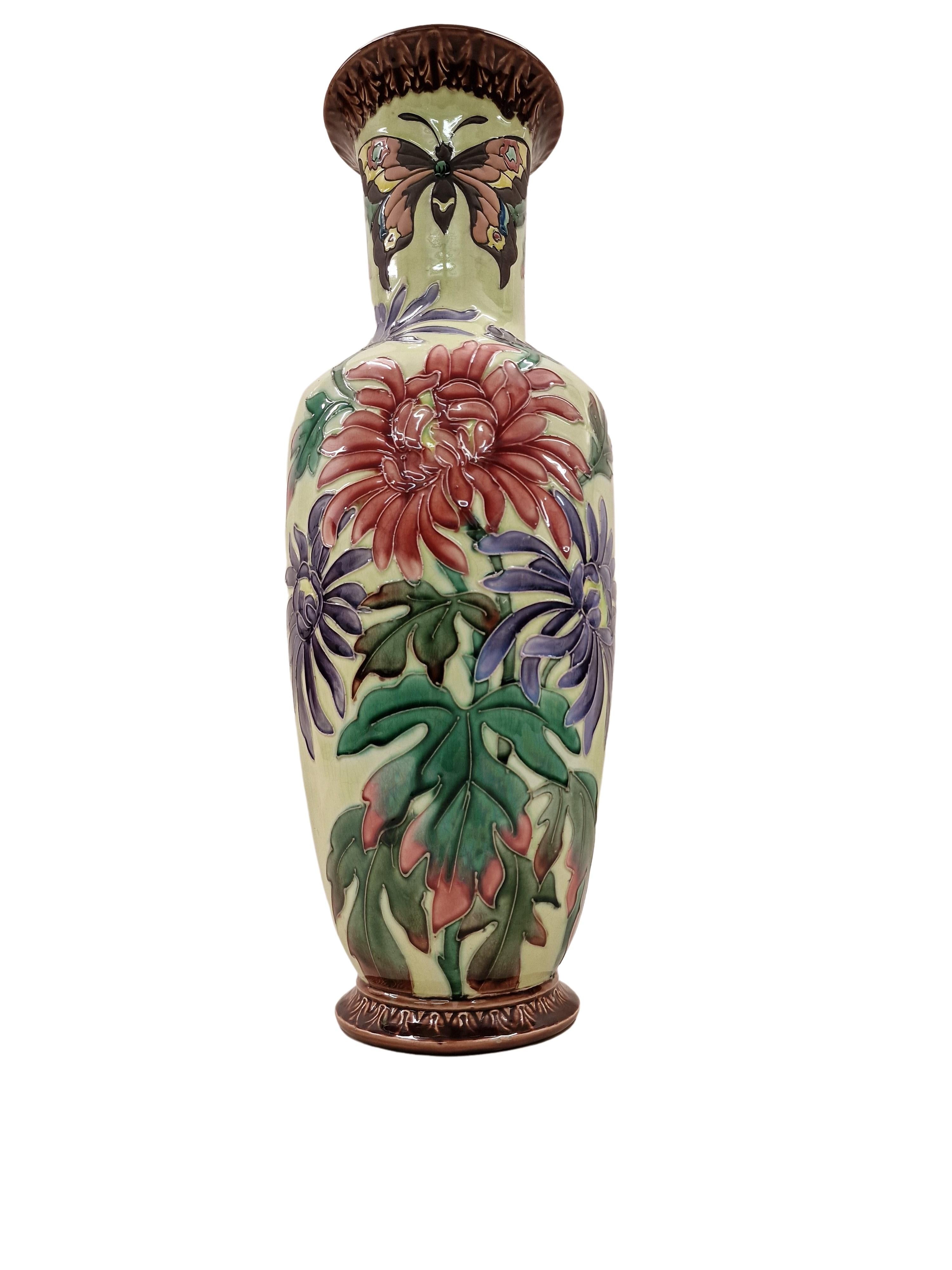High quality floor stand vase, from France from the Art Nouveau / Art Nouveau period, made around 1910. 
This vase is a huge ceramic piece with a exceptional, colourful decor of chrysanthemums and butterflies.
This exciting surface structure is