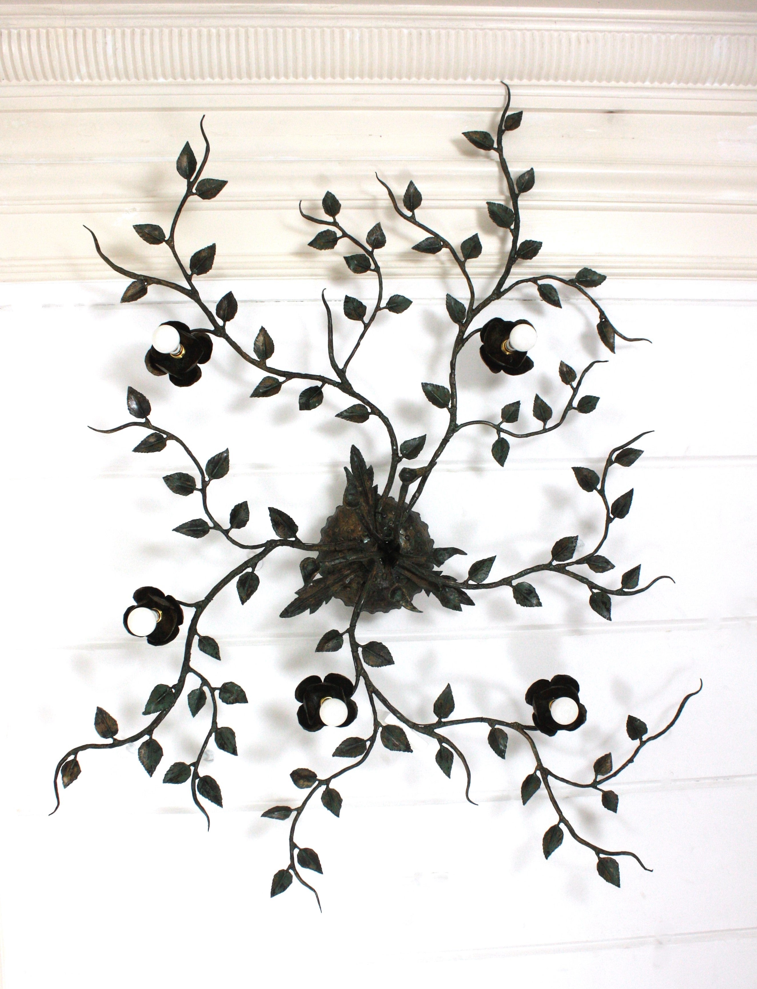 Monumental  Rosebush Tree Ceiling Flush Mount, Hand Forged Gilt Iron, Spain, 1940s. 
One of a kind Extra large size ( 63 in x 61 in ) hand-hammered gilt iron and green foliage flower bush ceiling light fixture with five flower lights.
This