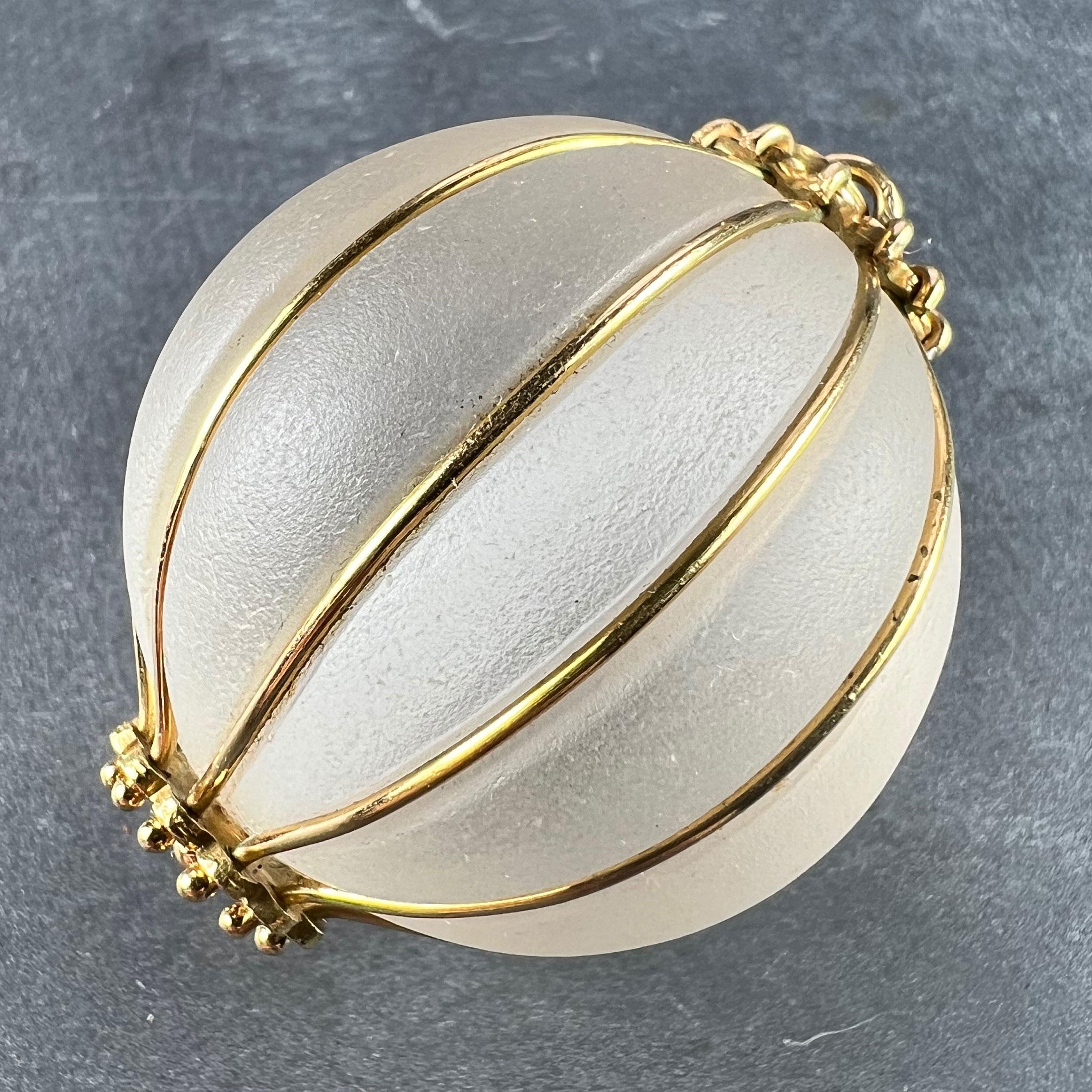 A huge spherical pendant designed as an enormous frosted glass gadrooned sphere with 12 raised and curved segments separated and defined by 18 karat (18K) yellow gold wires to decorative finials at each end. Stamped with the owl mark for French