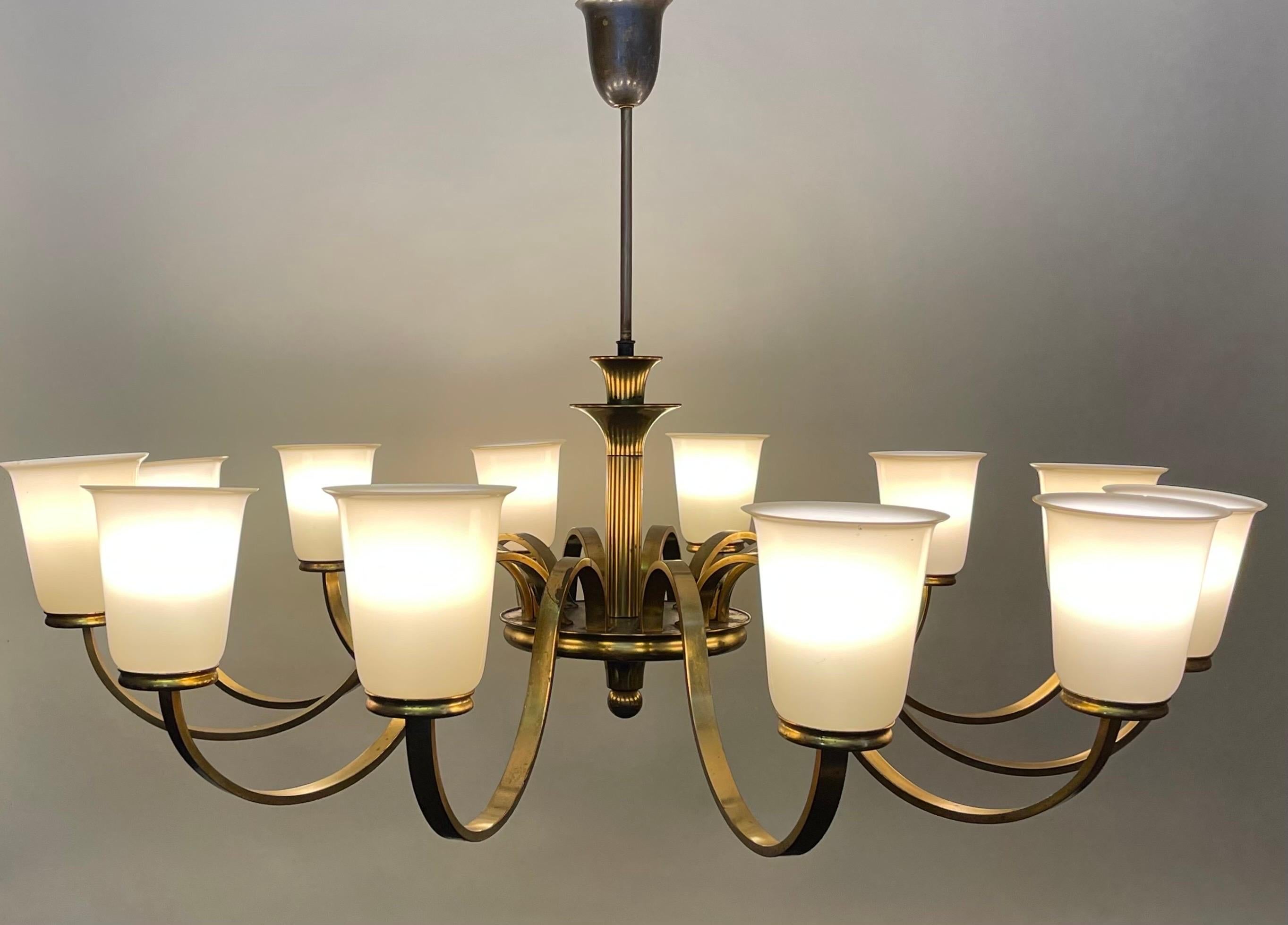 A huge Art Deco German brass and opal glass chandelier, 1930s.
Socket: 12 x e27 or E26 ( also for US standards).
 