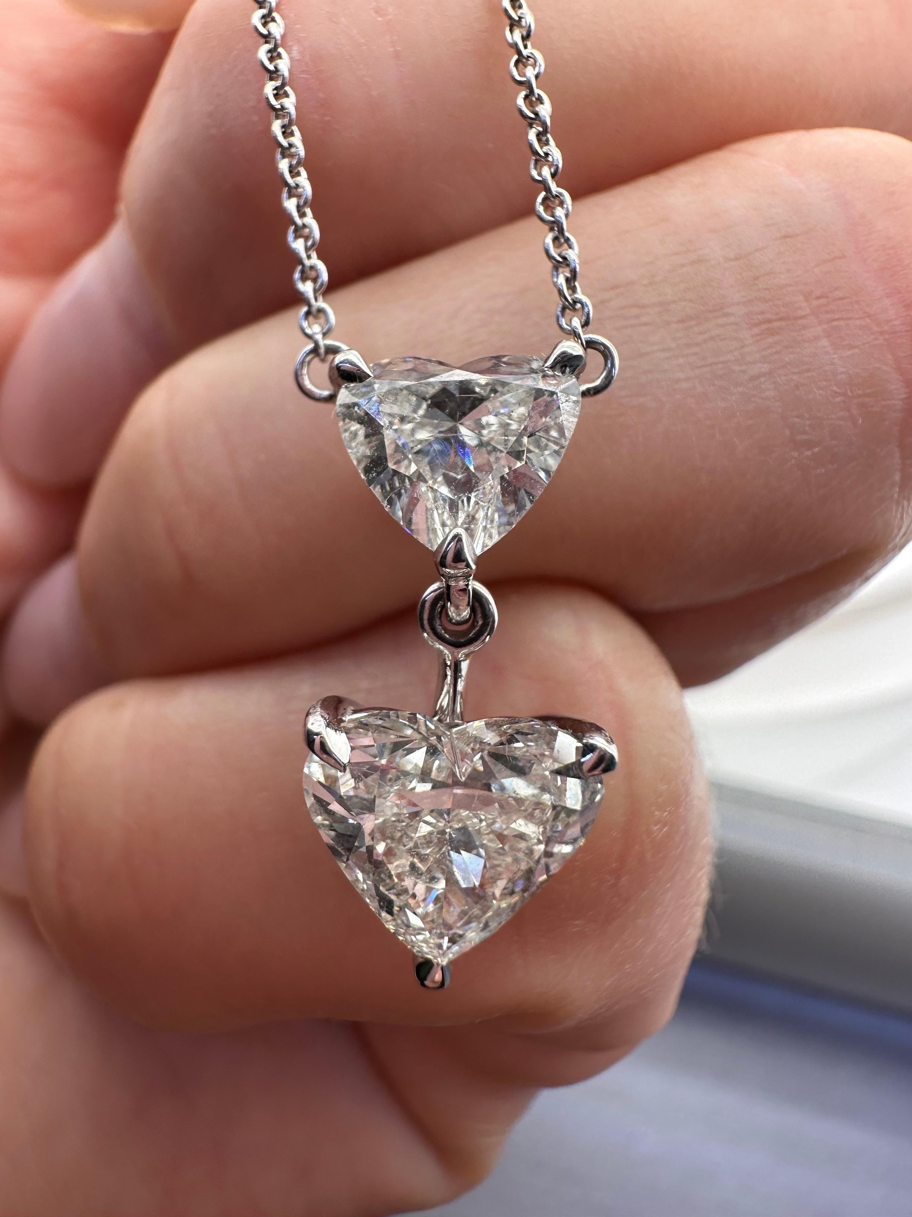GIA certified heart brilliant in 18KT white gold, stunning necklace with small heart diamonds and 2 large daimonds hanging in the front. Both diamonds are certified GIA diamonds that look stunning on this necklace, this is a rare piece of jewelry