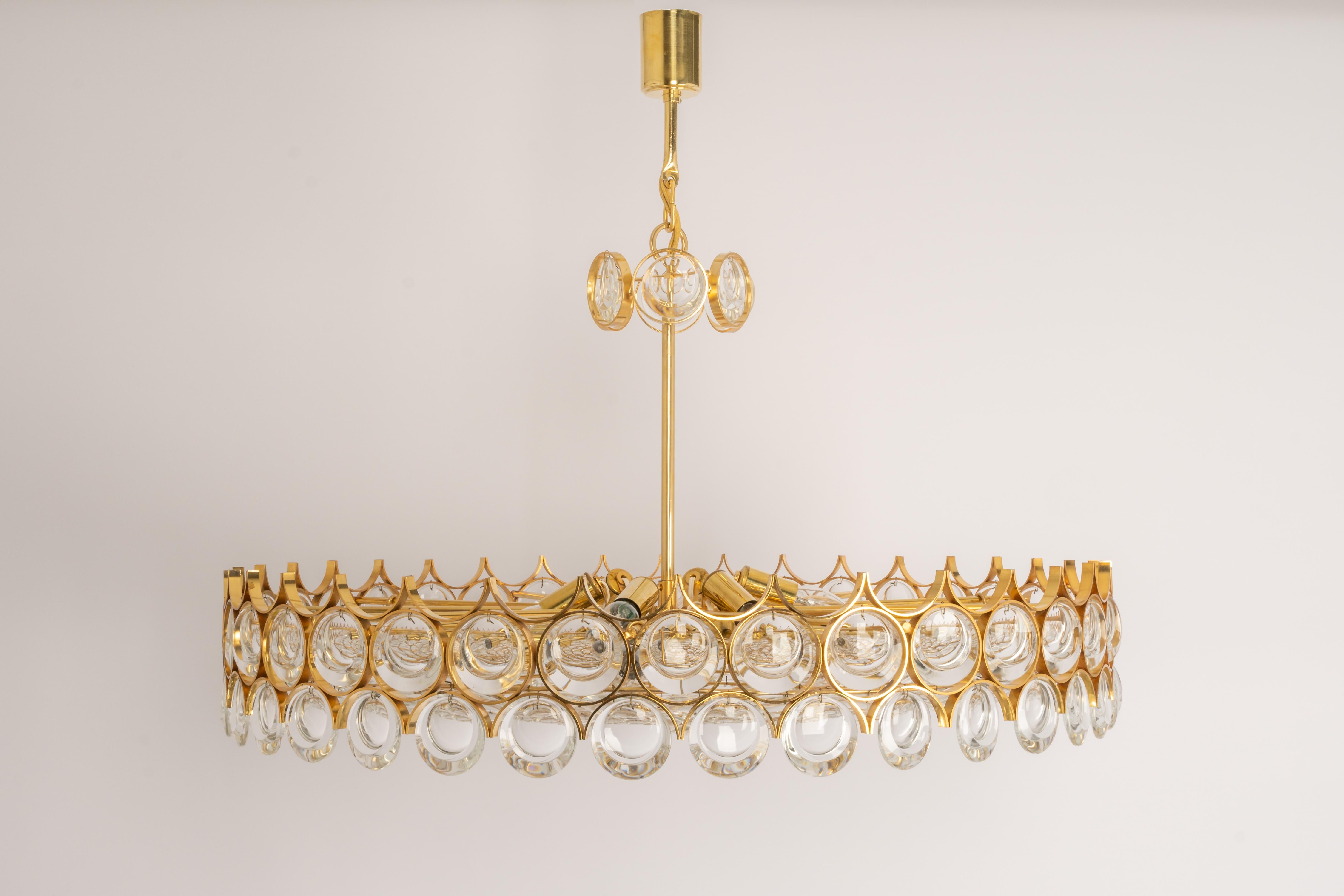 A wonderful and high-quality gilded chandelier or pendant light fixture by Palwa -Design Sciolari, Germany, 1970s.
It is made of a 24-carat gold-plated brass frame decorated with individual 