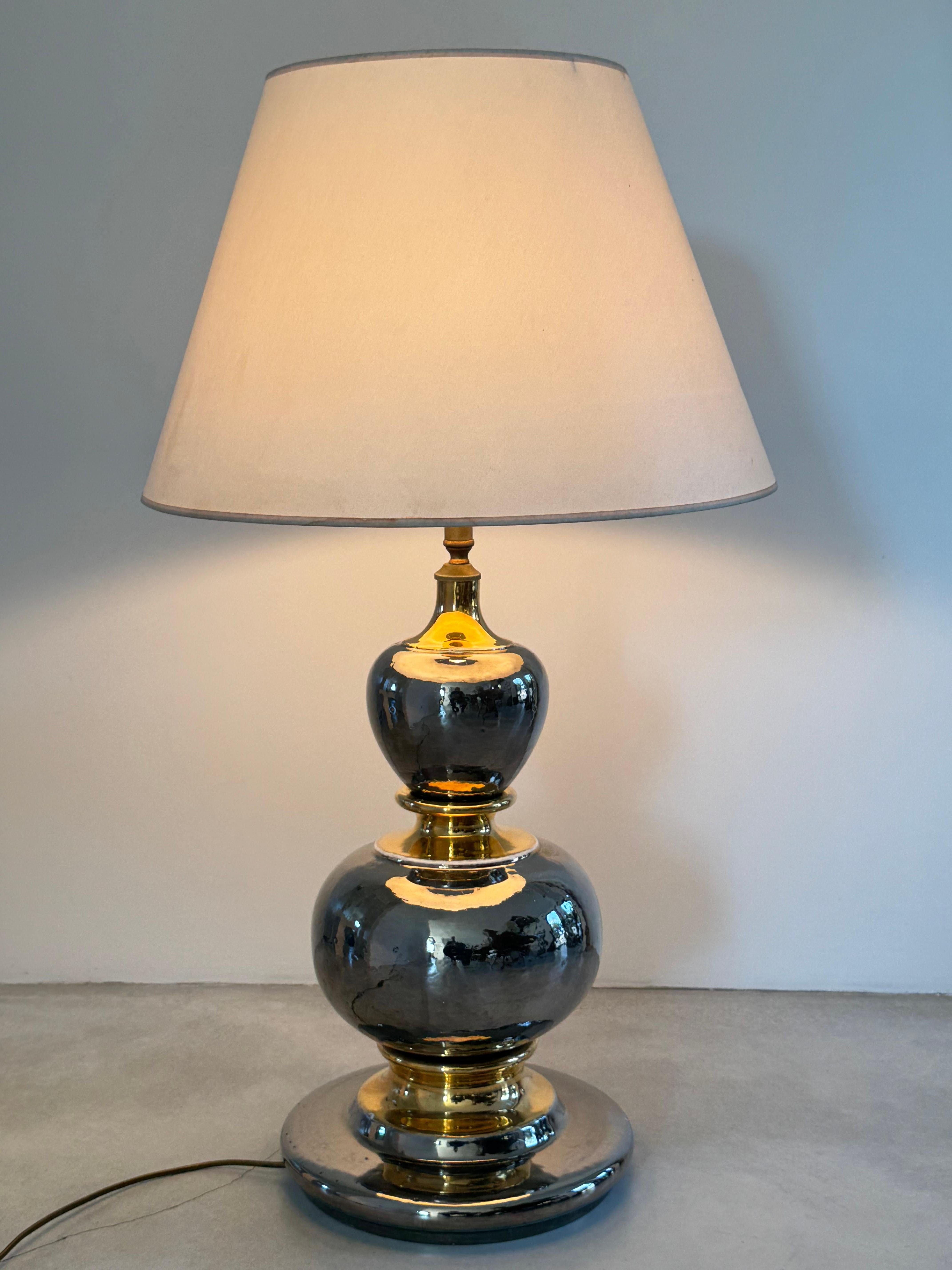 Énorme lampe en céramique italienne.

Cette lampe en céramique or et argent est composée de 3 éléments assemblés en leur centre par une épine métallique.

Magnifique miroir et émail métallisé, belle cuisson de la céramique.

Inspirée du design des