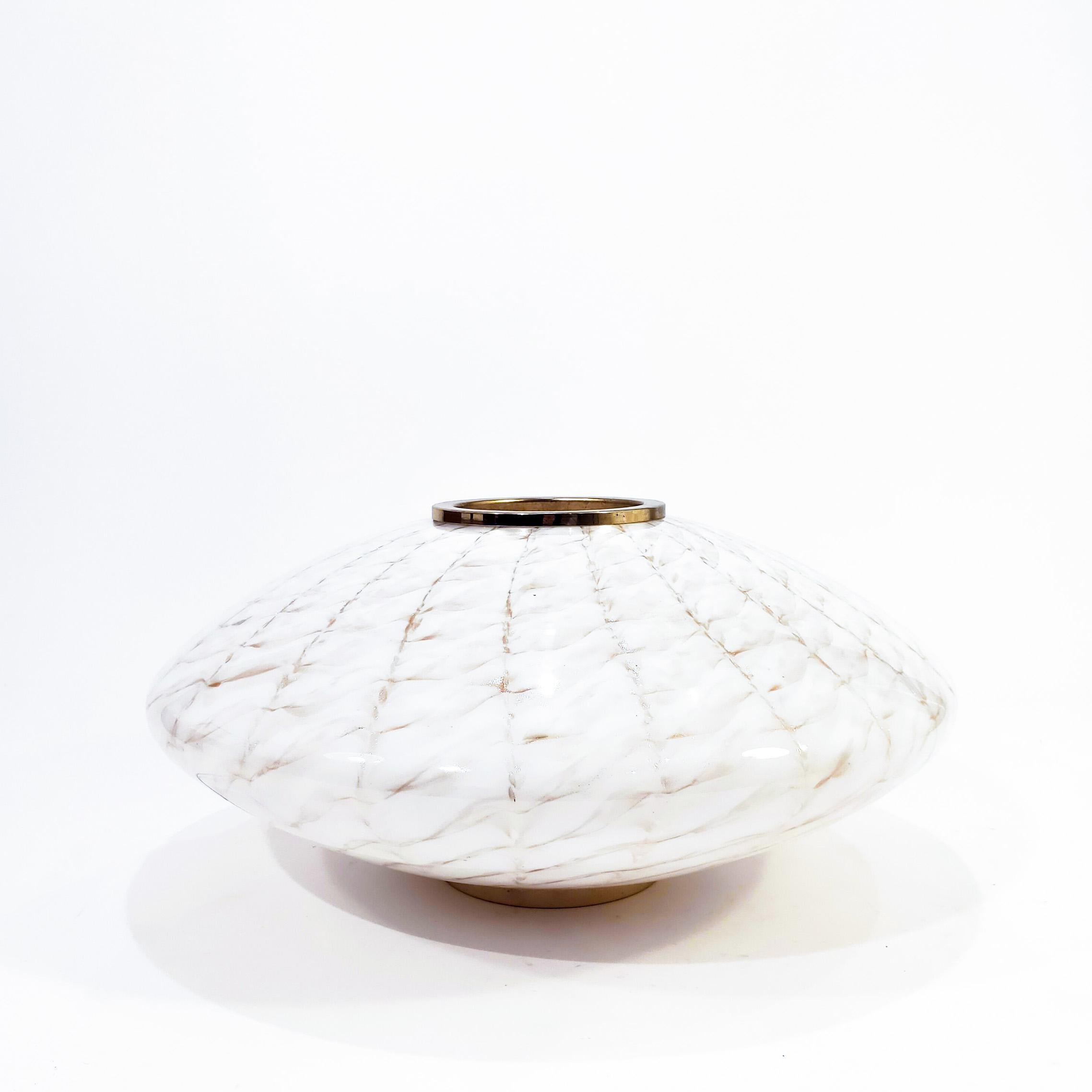 Stunning table or floor lamp made of hand-blown Murano glass designed by F. Fabbian, 1970s. Flattened spheriacl shape and totally round, made of milky or opaline Murano glass with golden sparkles using a very particular and curious glass technique