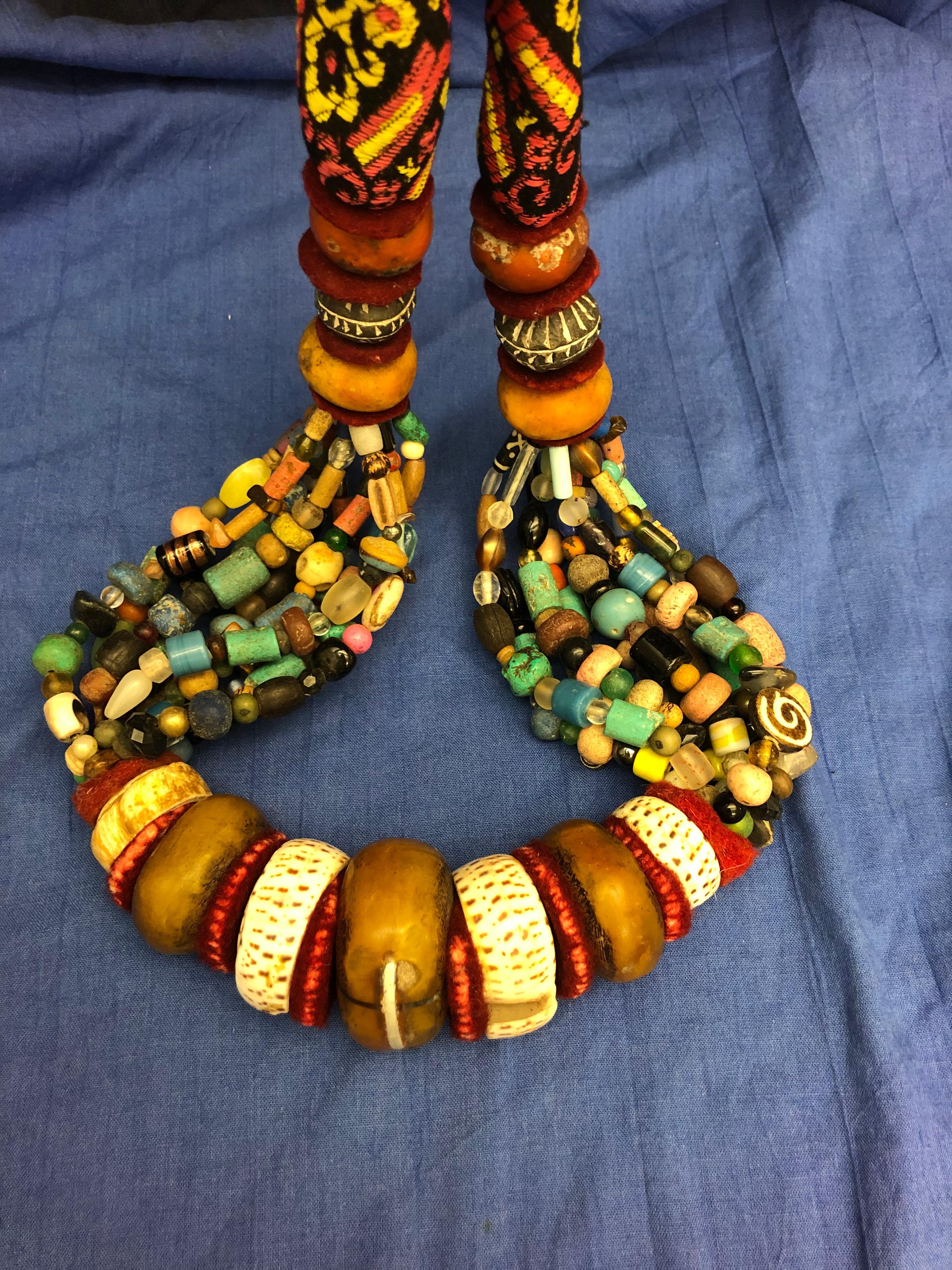 This giant handmade Berber necklace is intended to be worn during tribal wedding celebrations or to be displayed on the wall. The centre of the necklace has a very large copal bead that has been repaired with a large silver staple. Two snail shells