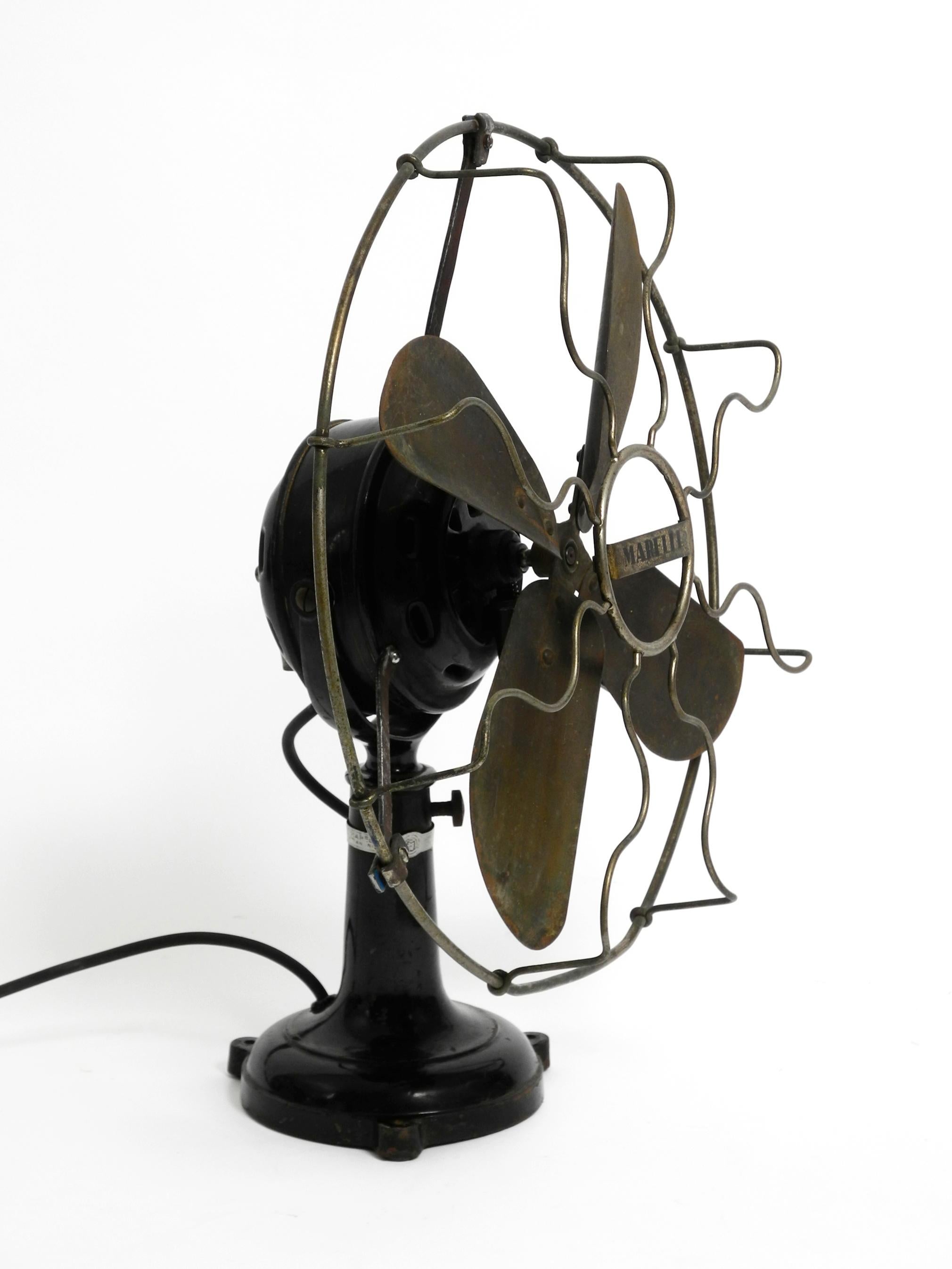 Very beautiful, huge original 1930s industrial metal table fan from Marelli. Made in Italy.
Very good, complete original condition. All parts original and complete.
Wonderful patina for its almost 100 years.
Steplessly tiltable and rotatable and
