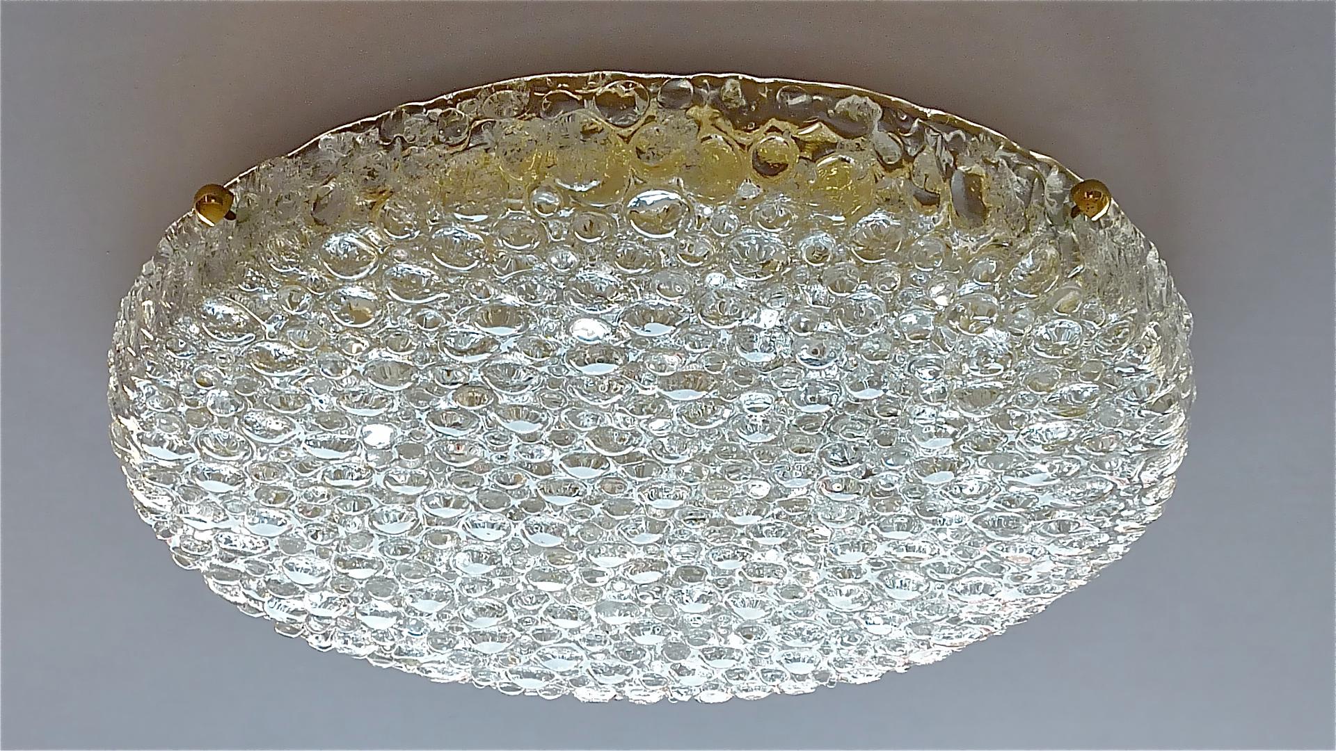 Huge round extra large textured Murano glass flush mount or ceiling light made by Hillebrand Leuchten, Germany, 1960s. The Midcentury Modern light fixture has a solid patinated brass base, six porcelain fittings for six E14 standard screw bulbs